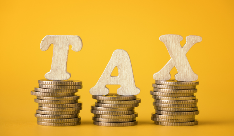 How to file taxes - pic of the word tax on top of coins