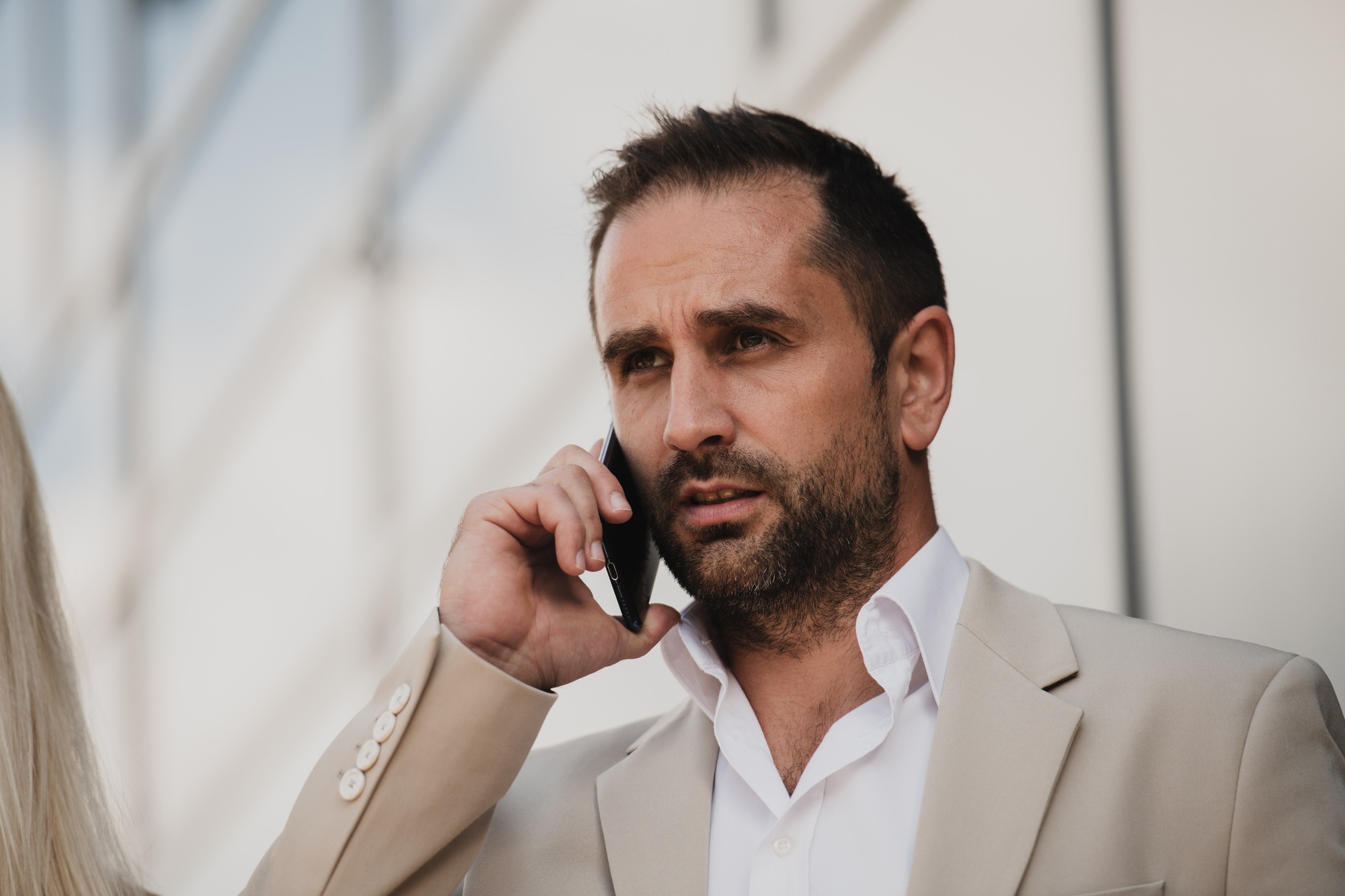 A businessman using his smartphone outdoors, showcasing the seamless integration of technology and