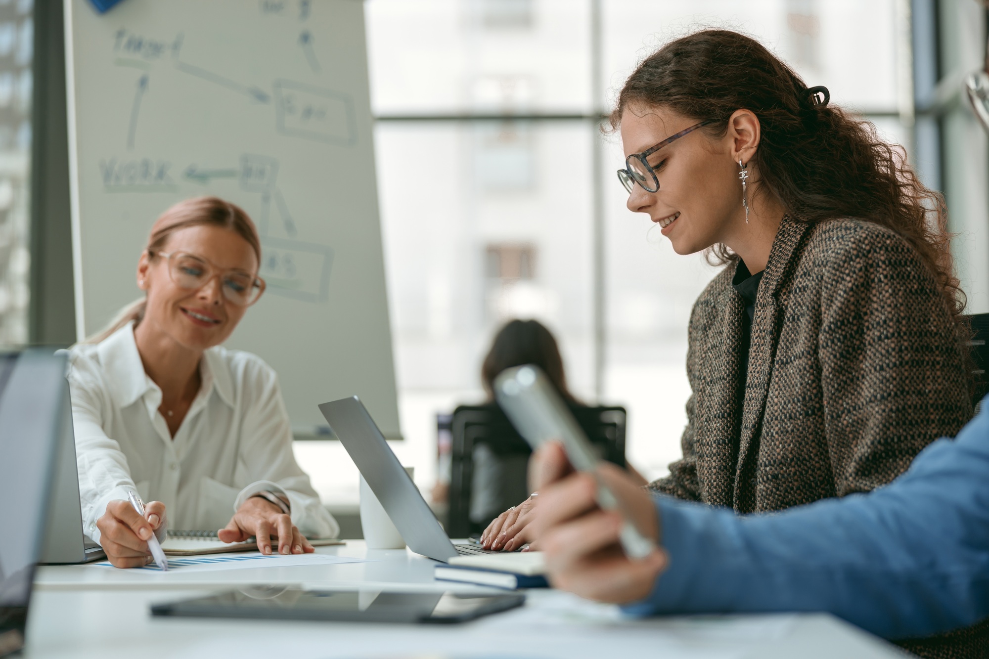 Businesspeople working together in modern coworking sitting at desk. Teamwork concept