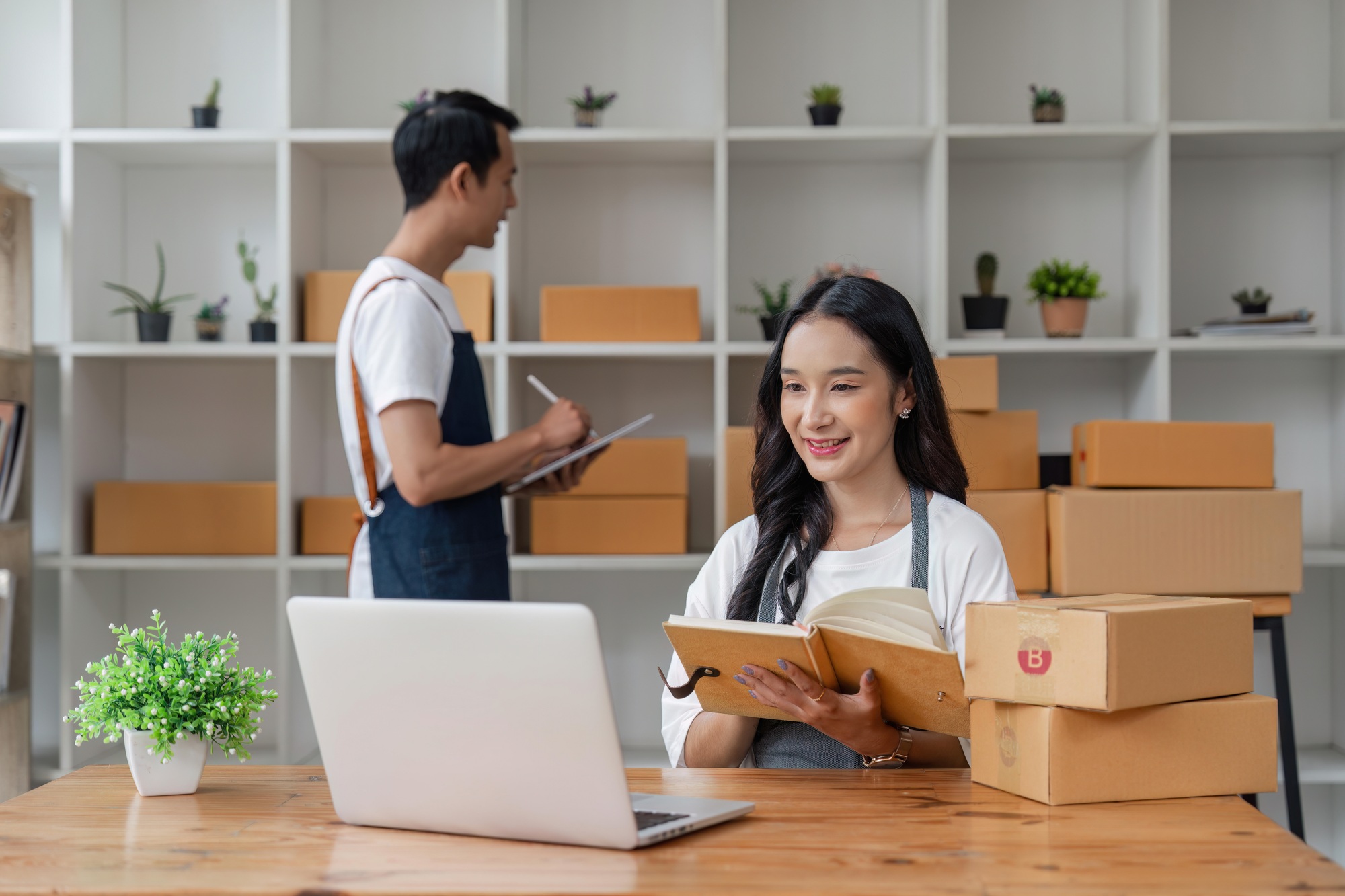 Couple working online with laptop computer and success to selling product online at home office