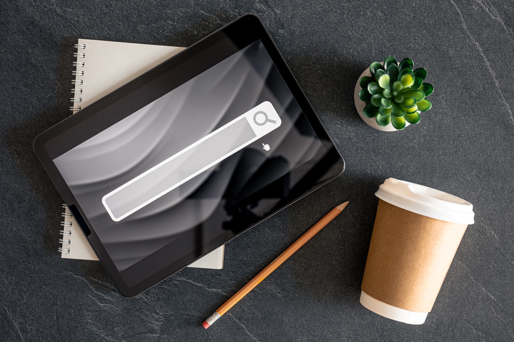 Digital tablet with internet browser search bar on screen.
