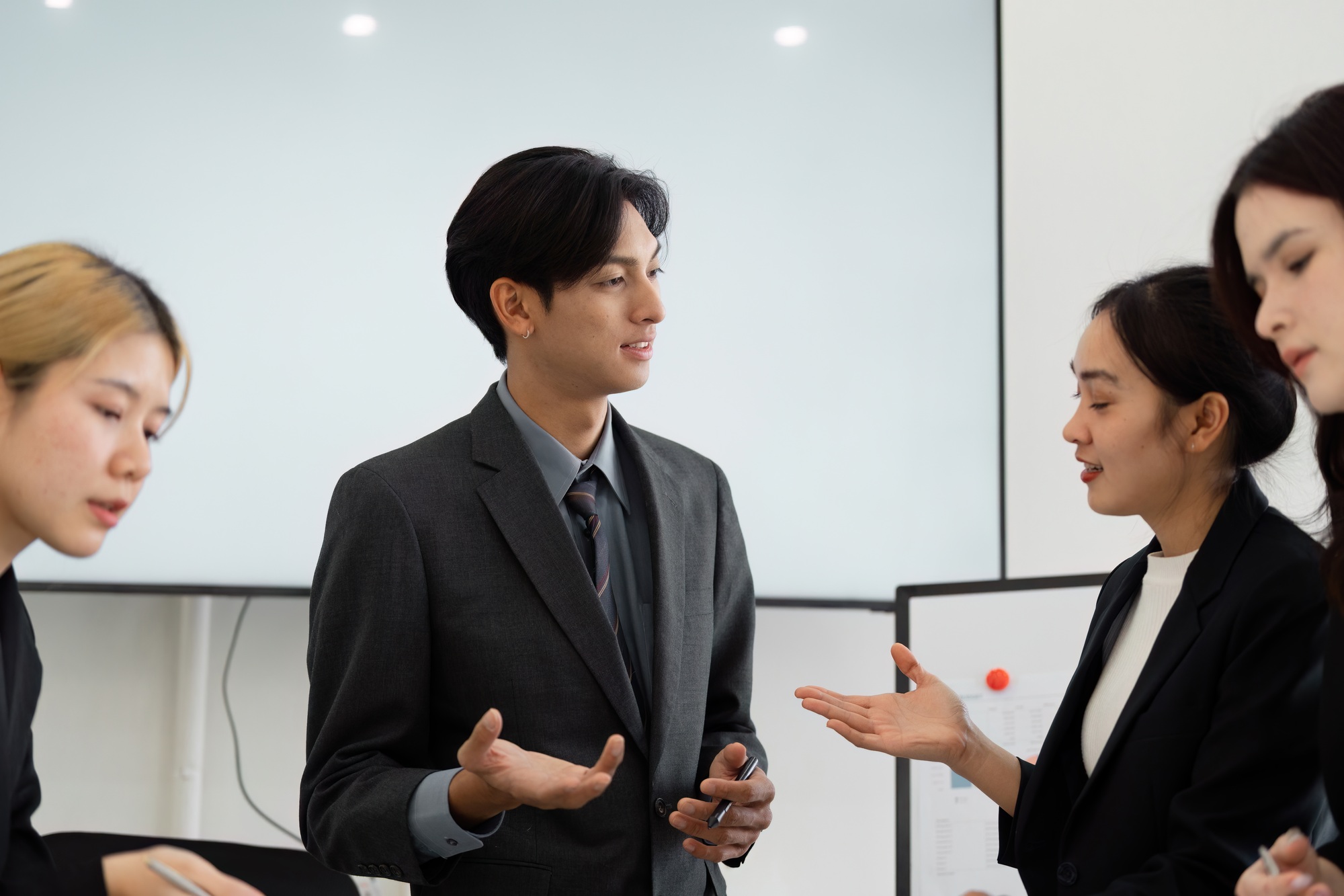 Diverse business team discussing ideas and sharing insights in a meeting.