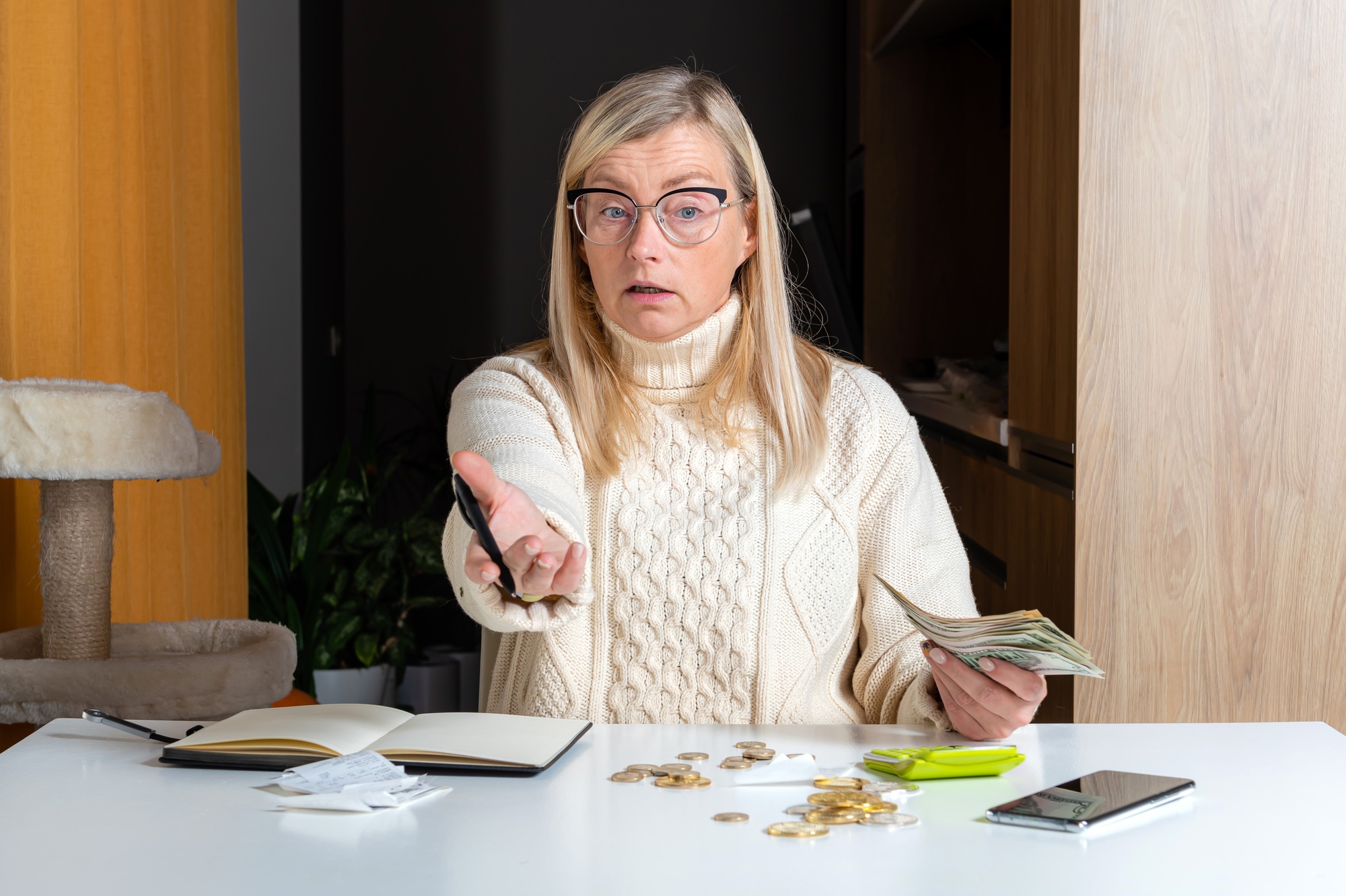 emotional freelance woman calculating budget in home office, work from home concept