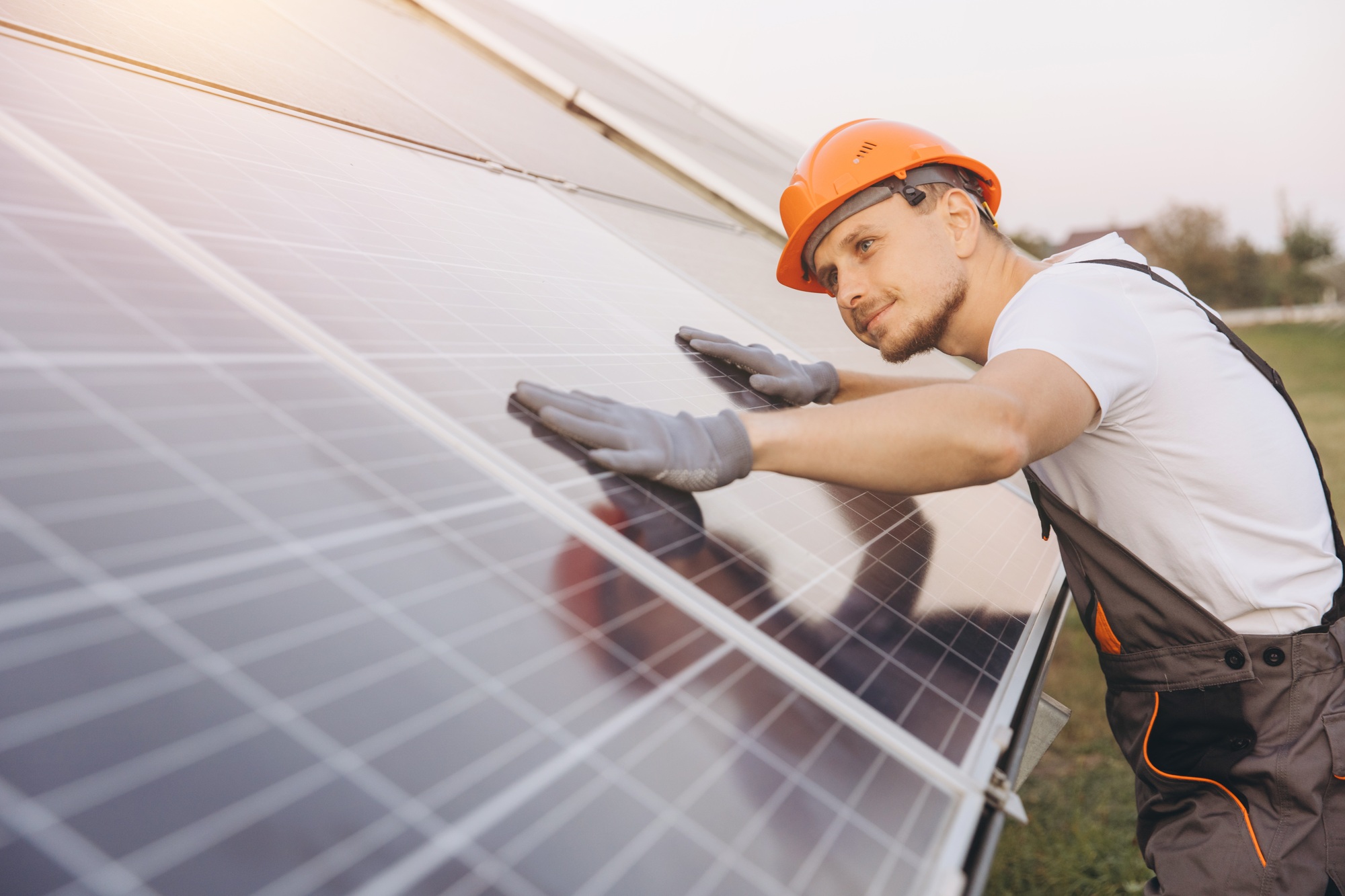 Engineer Inspecting Solar Panels for Efficient Energy Production