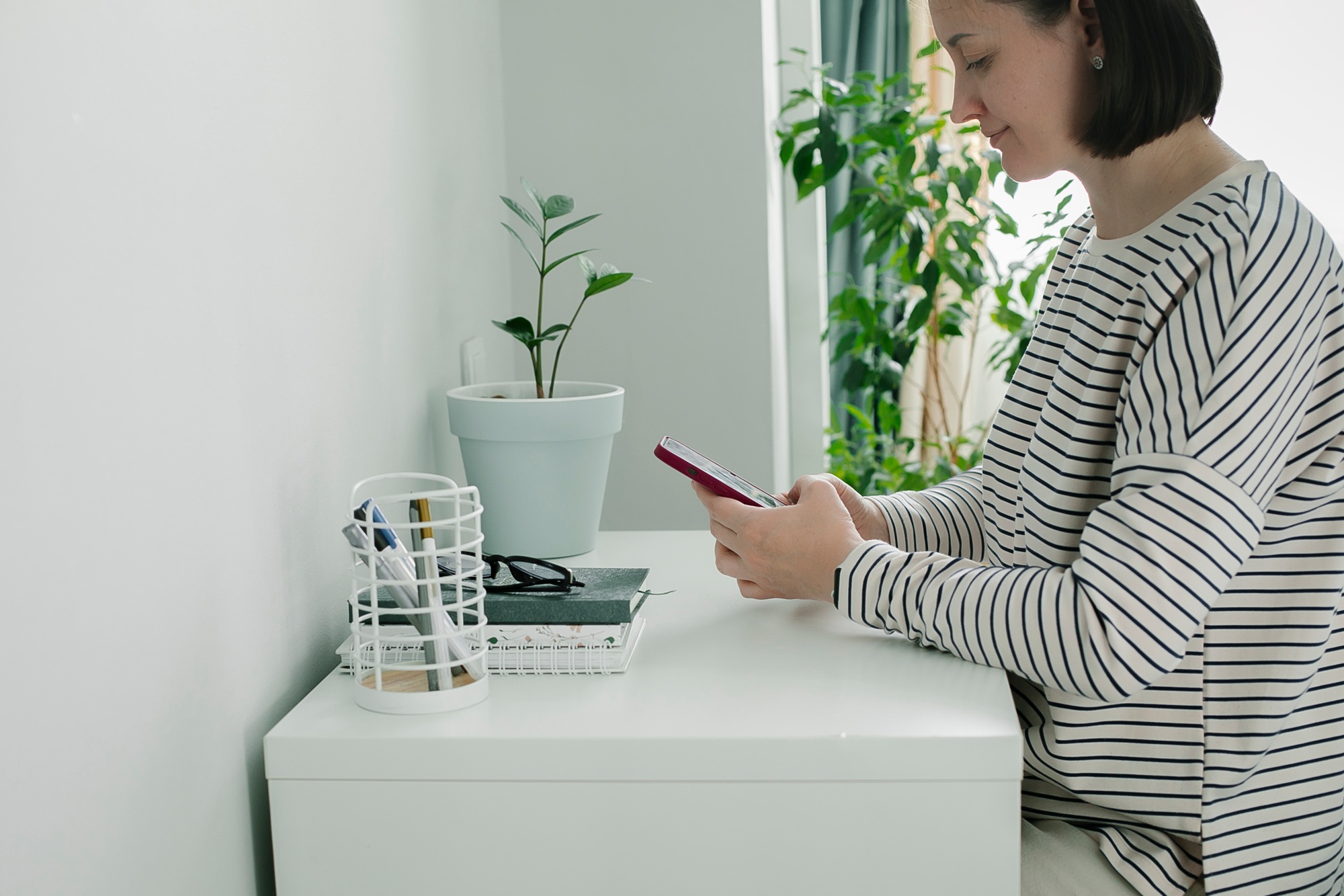 Freelancer smiling woman using smart phone. Lifestyle, social media, small business concept