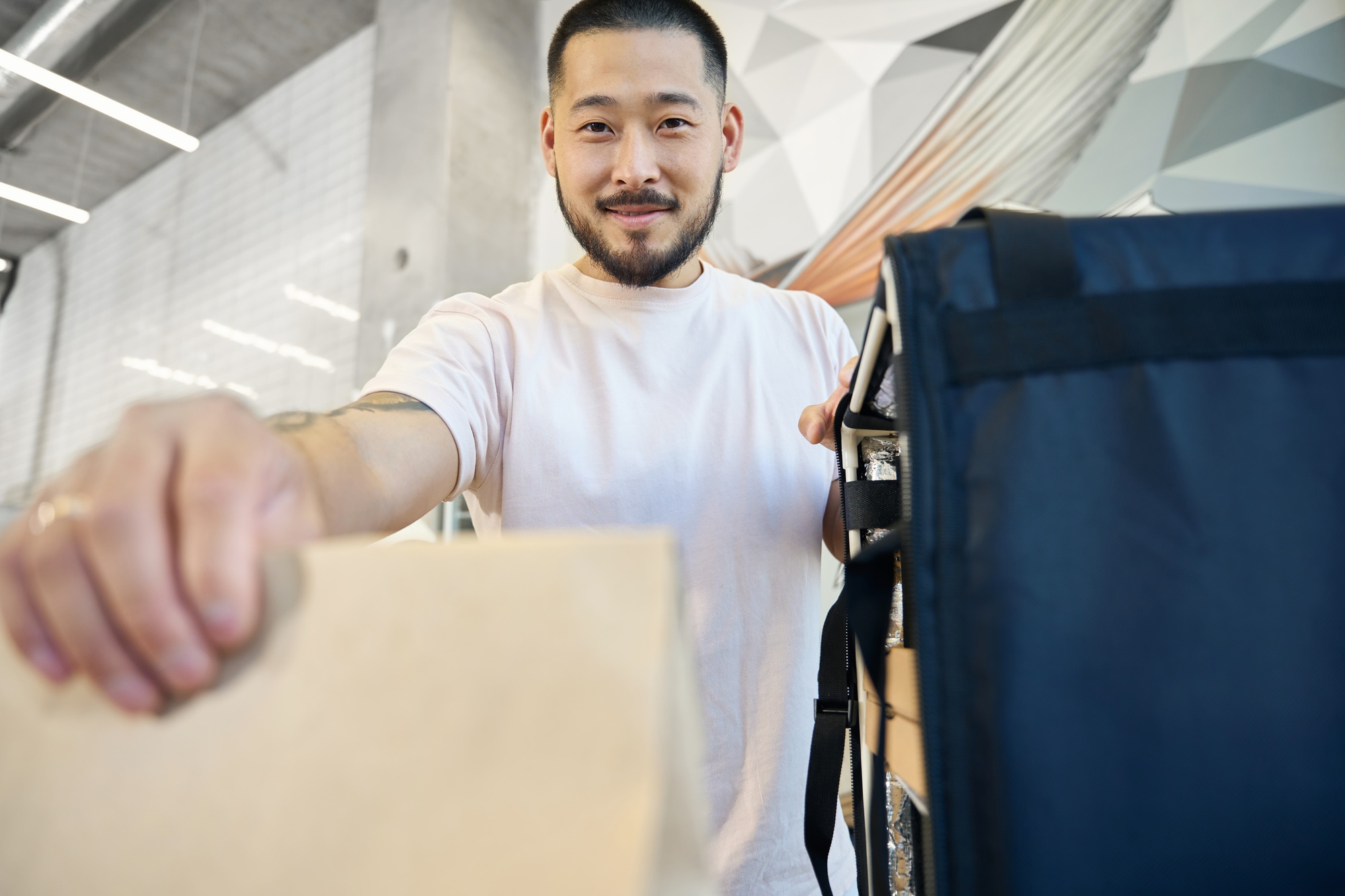 Lovely local cafe employee providing food delivery service
