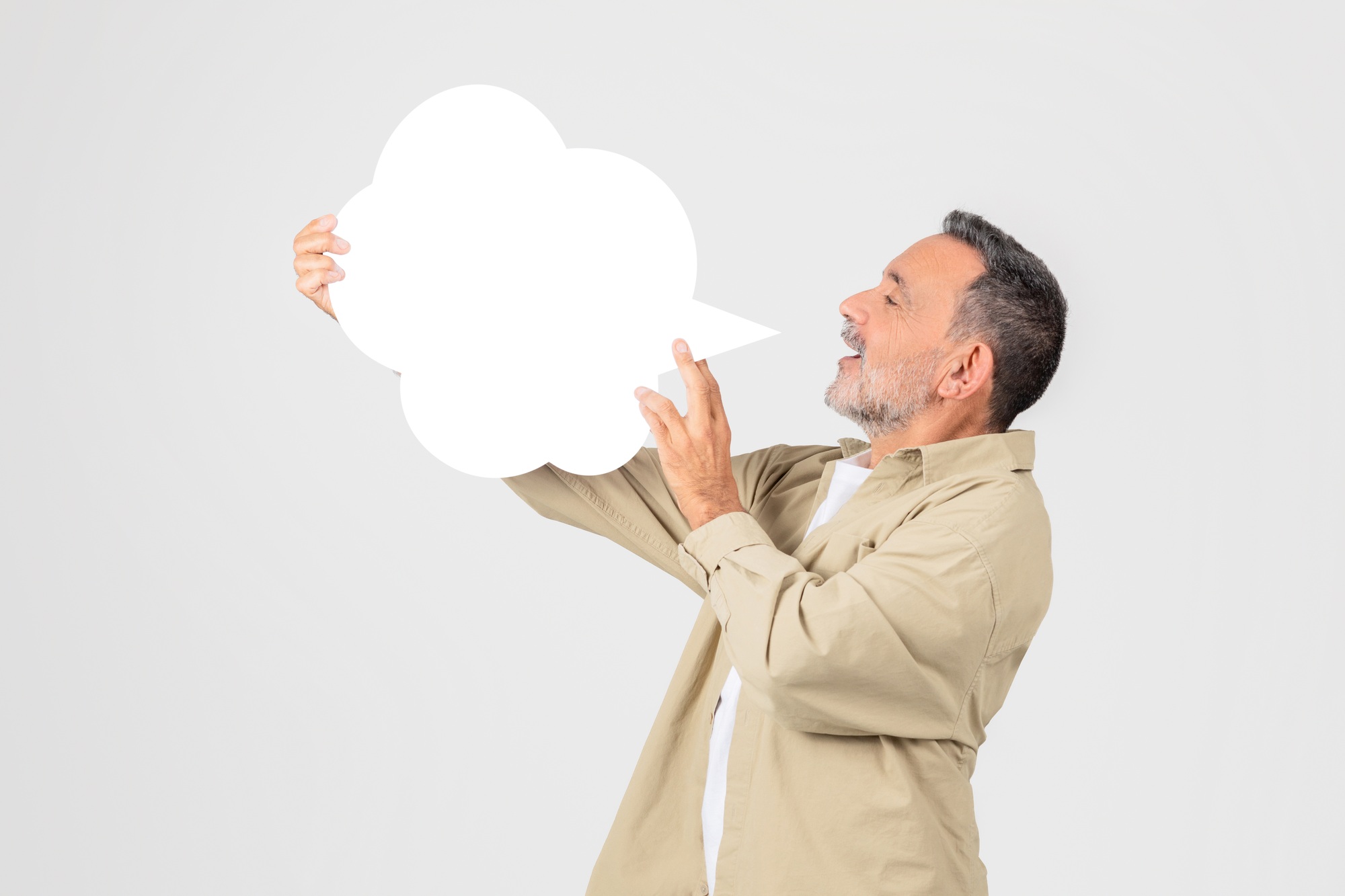 Man holding a blank white speech bubble