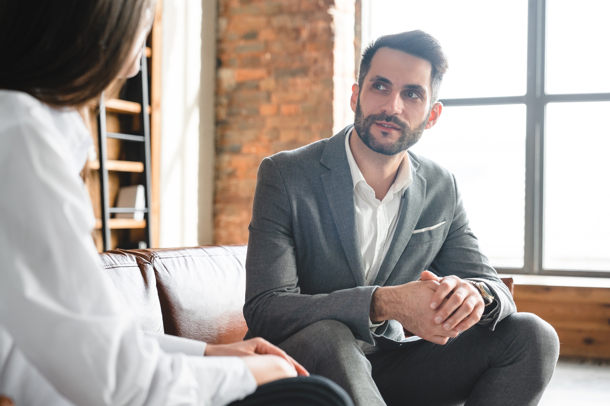 Two business partners having conversation about job related issues in modern office