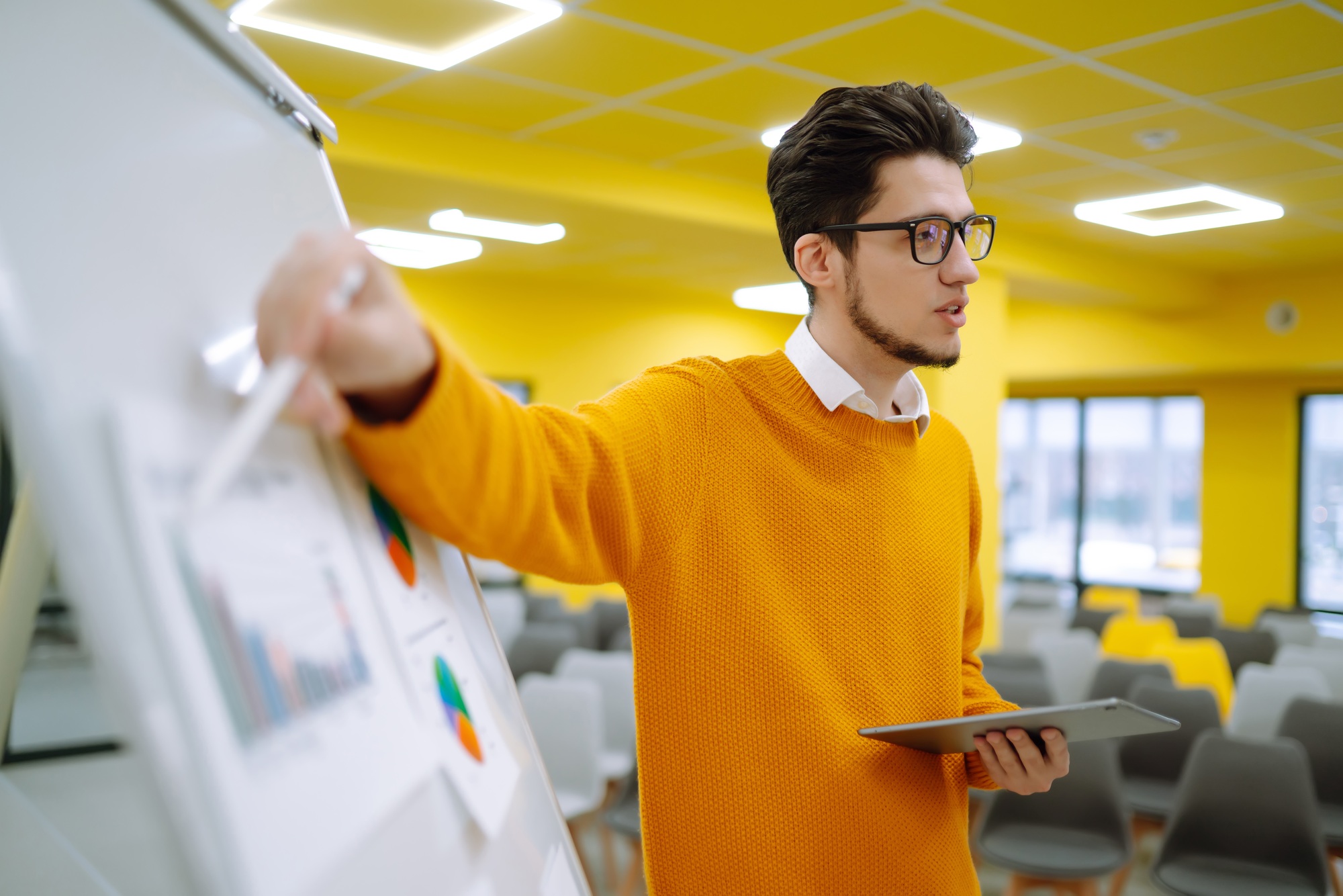 Young man leader, presenter, make a business presentation at a conference in the office.