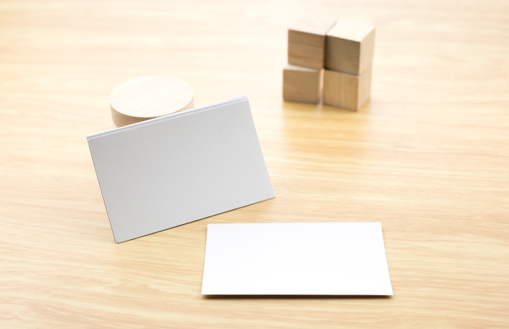 Blank business card on wood table with cube block