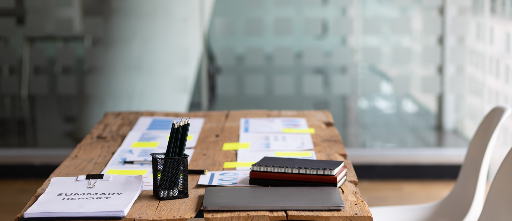 Business meeting minutes papers on wooden table in office.