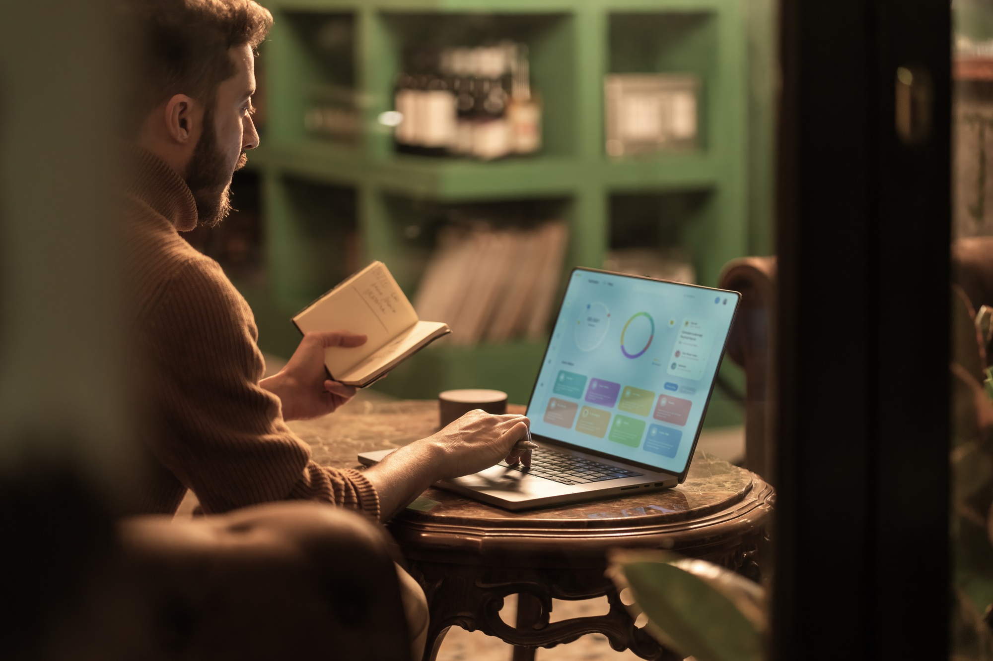Business professional working with analytics dashboard in modern cafe