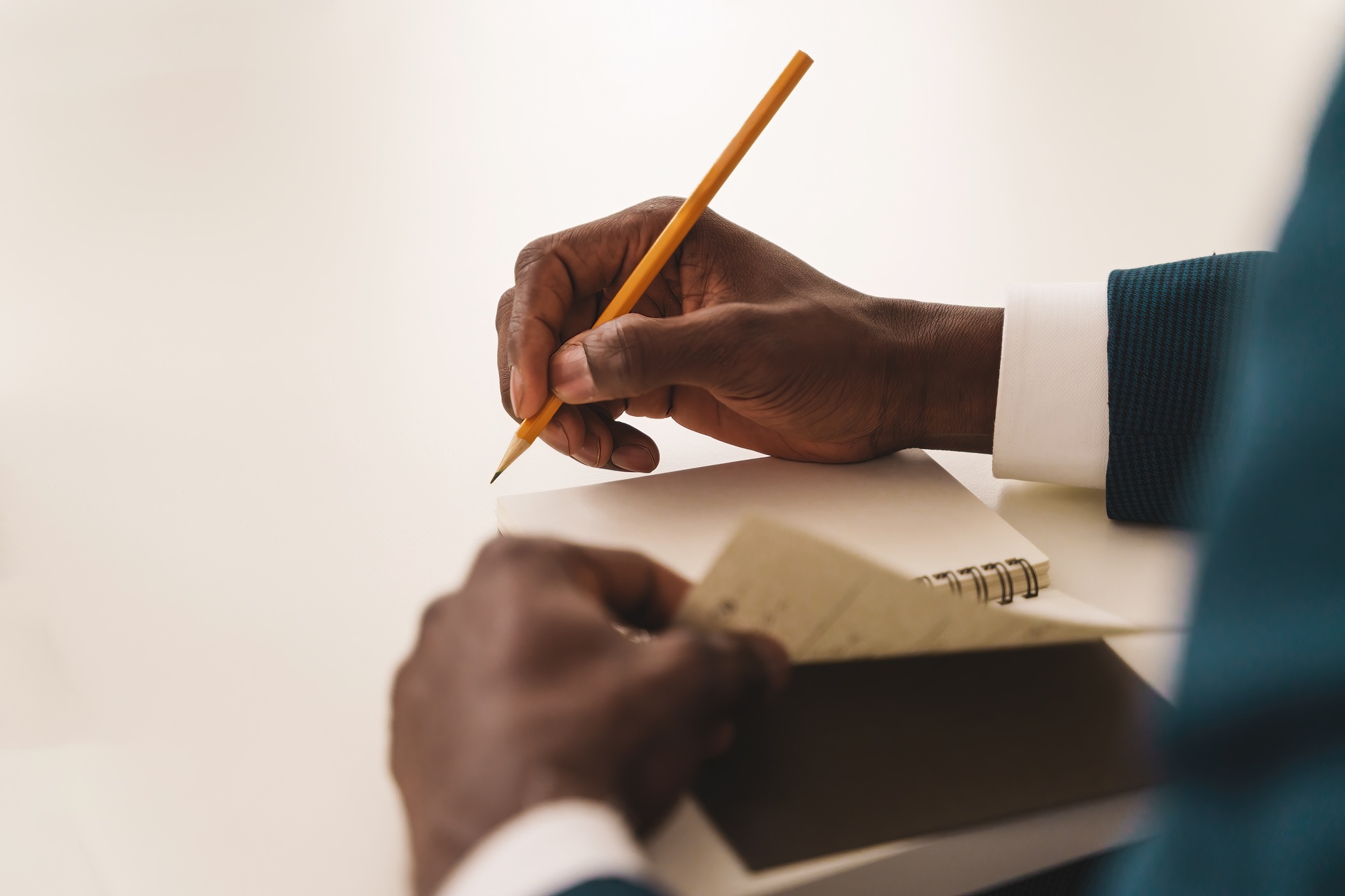 Businessman Taking Notes at Meeting - Executive jotting down ideas
