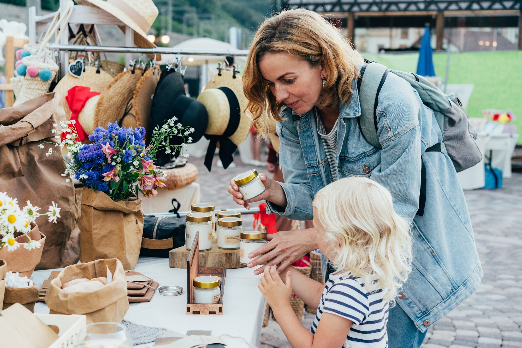 candids in public places. Mom and daughter are choosing candles at the market.