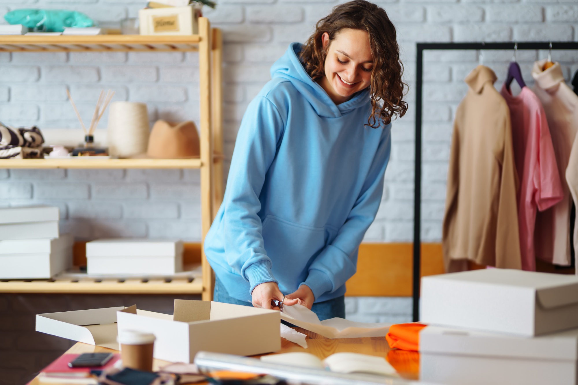Close-up of preparing a parcel on the table. Woman online store, small business owner, entrepreneur.