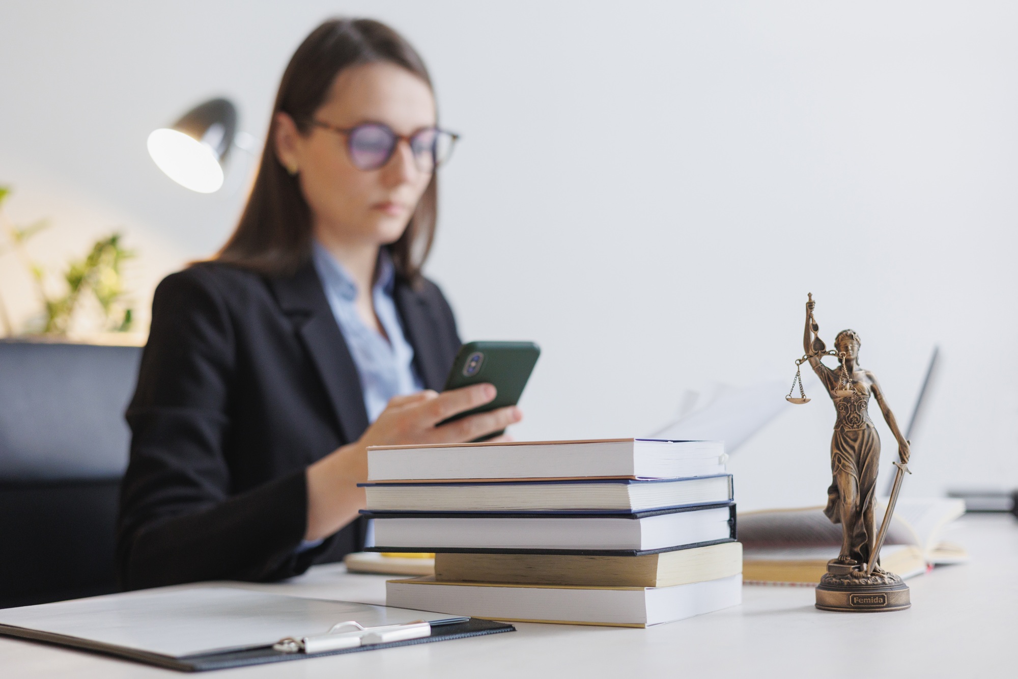 European female financier talks to clients by phone or webcam from a laptop. work in a law firm