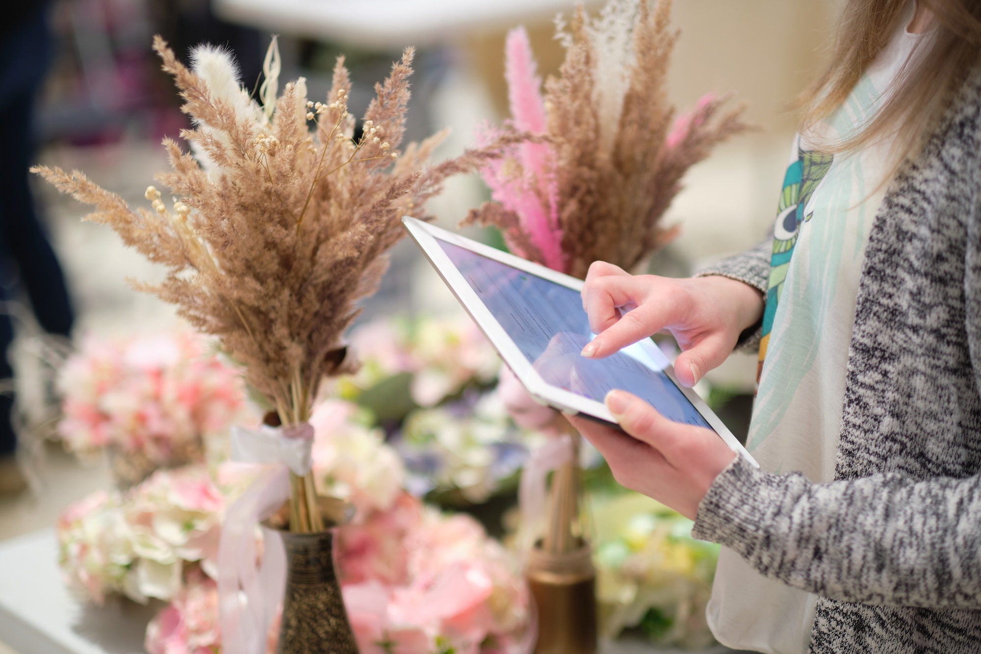female uses a tablet to advertise their products and communicate with customers.