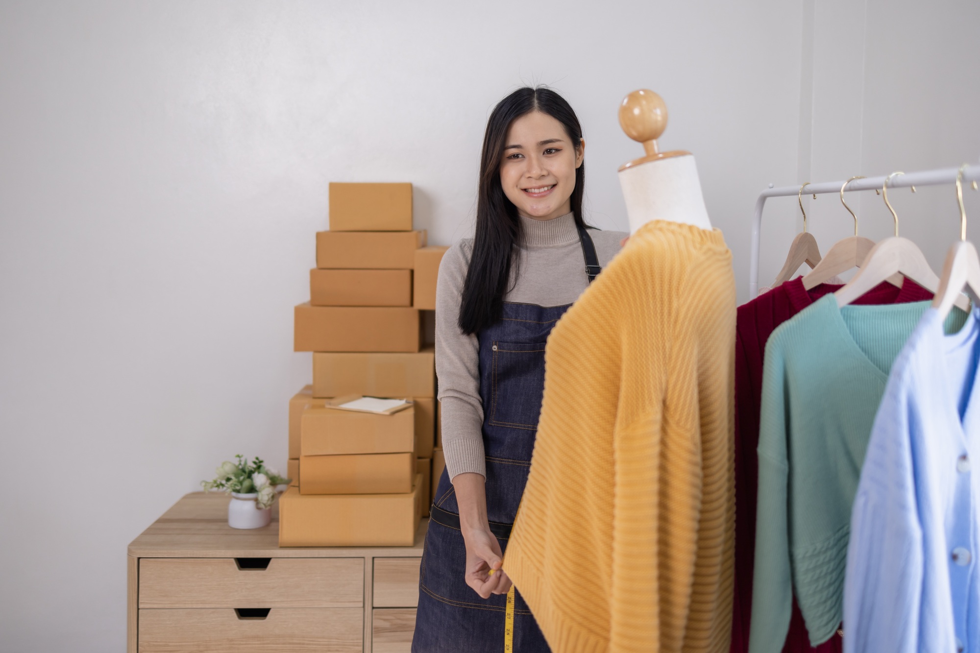 Portrait young attractive hipster asia female owner startup work happy with box at home prepare