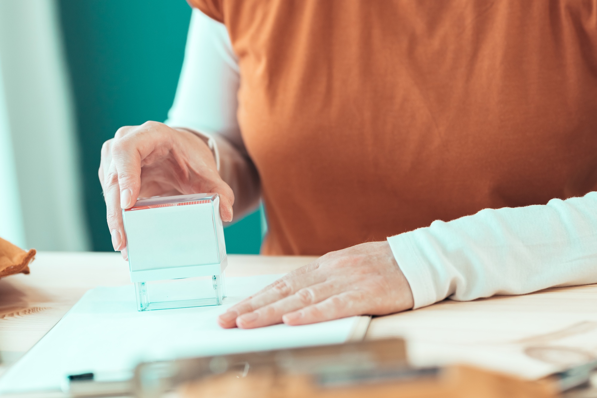 Self employed female carpenter is stamping project documentation