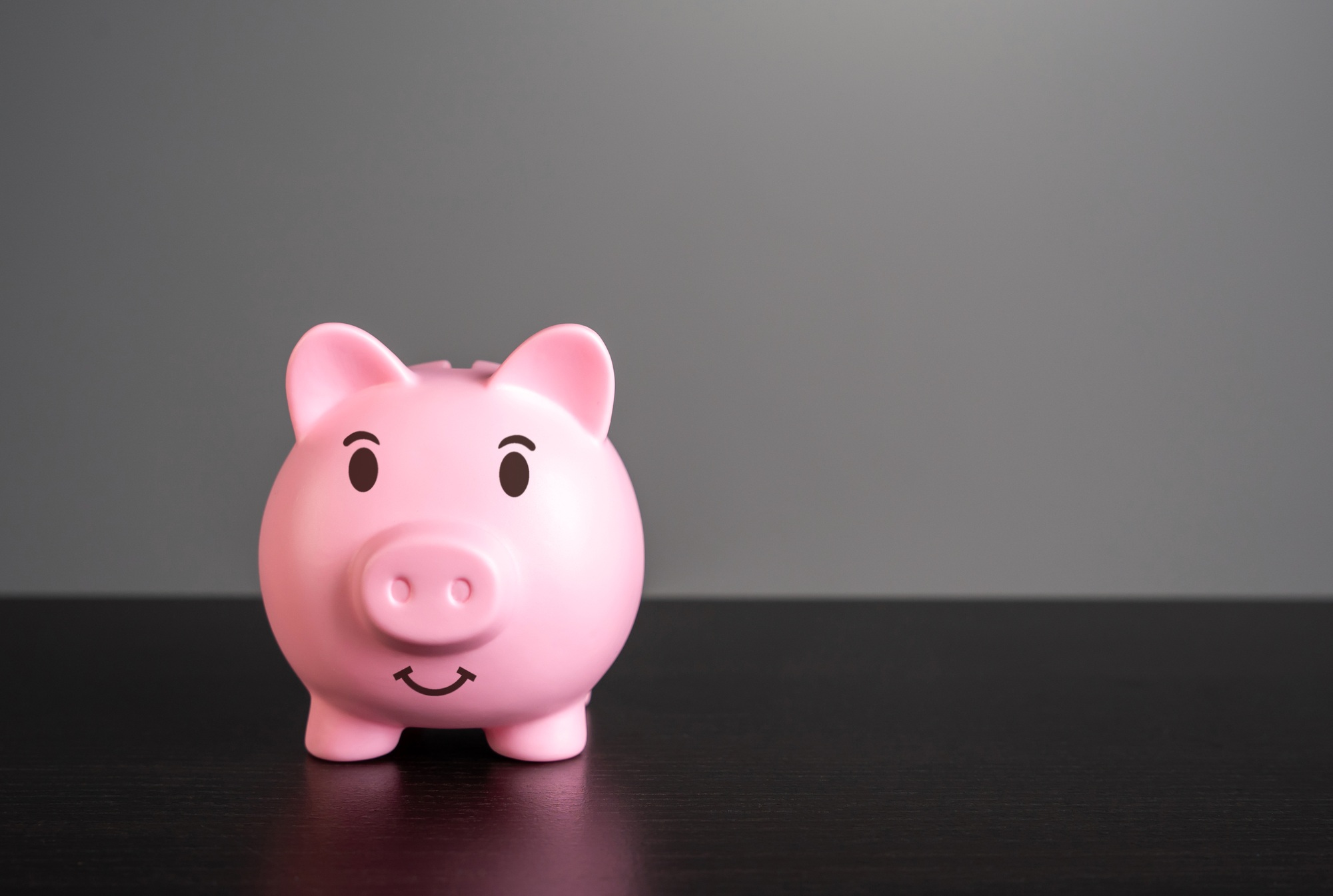 Smiling pig piggy bank with savings. Wealth and prosperity.