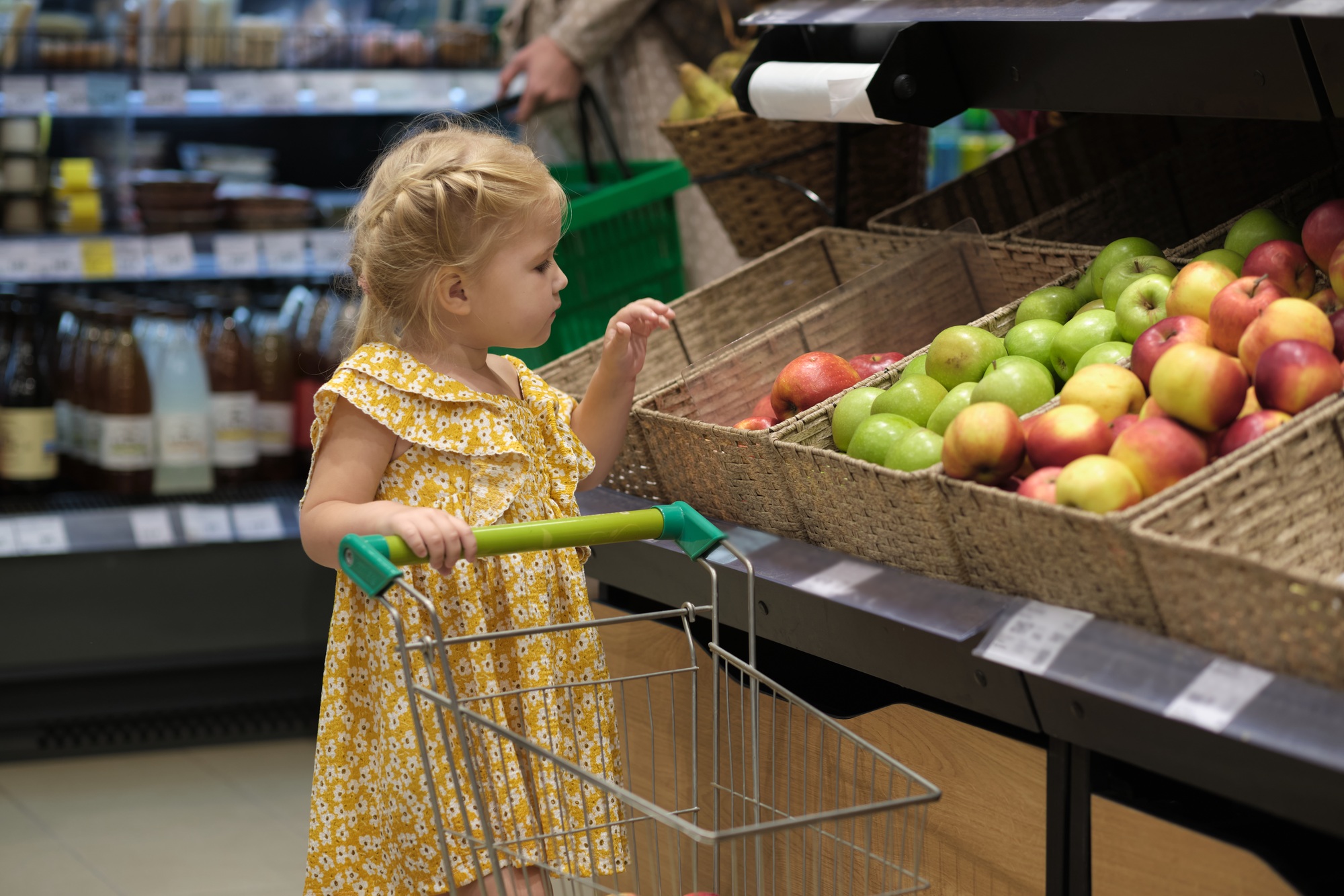 toddler pushing her own cart highlights how consumer habits can form early. Through Montessori