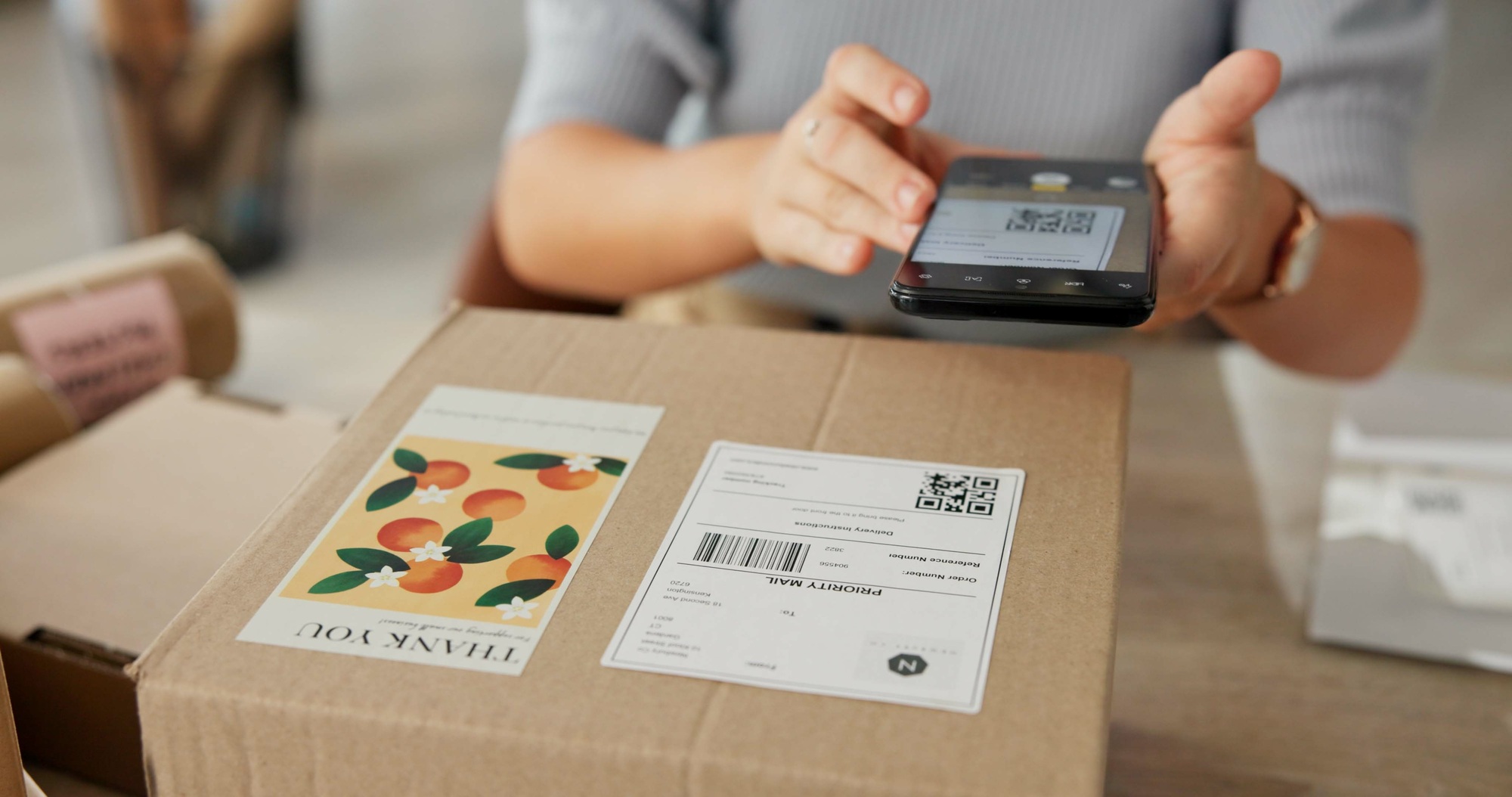 Woman, hands and phone to scan package for dropshipping, online information and parcel distribution