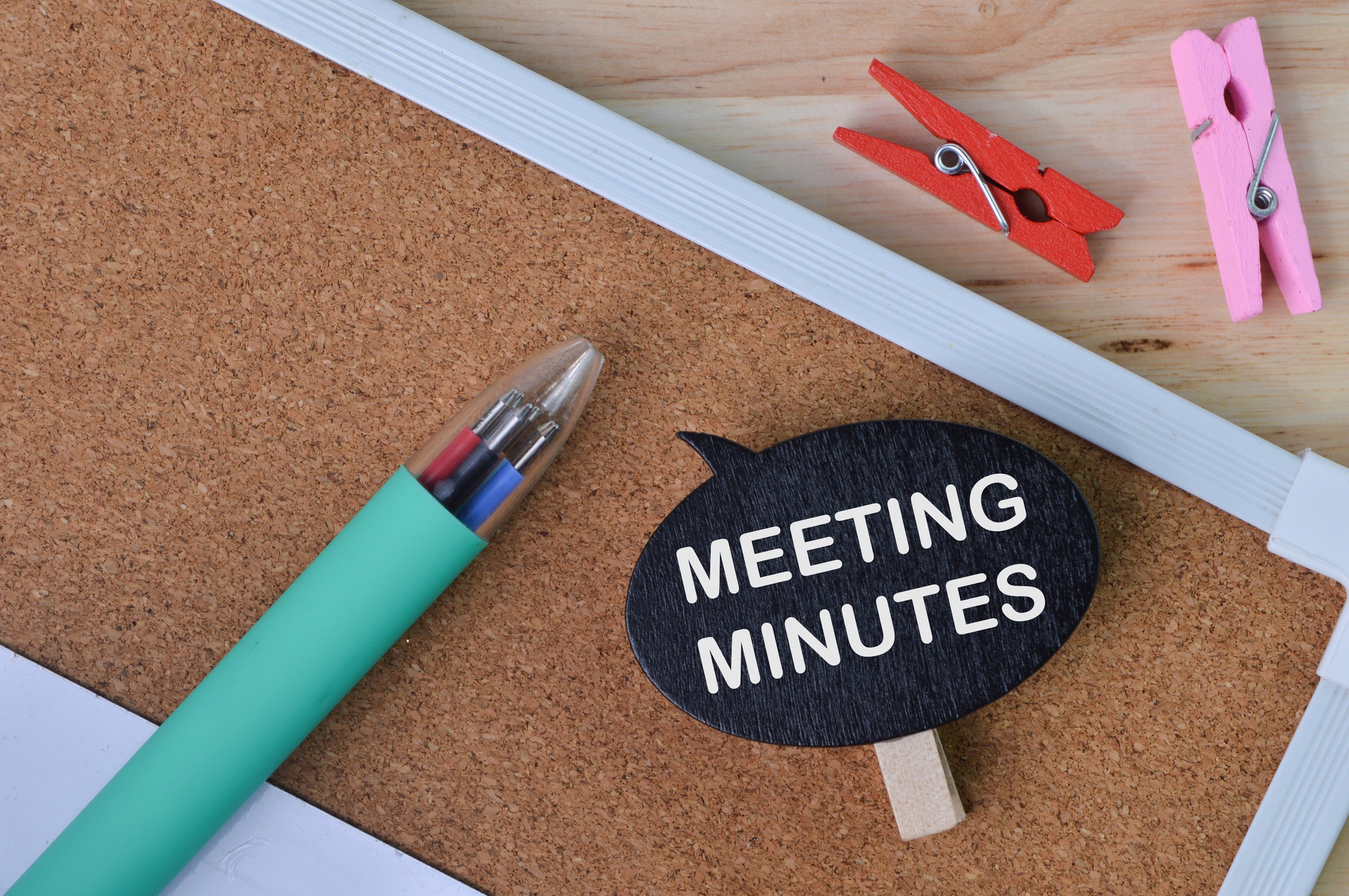 Wooden tag written with text MEETING MINUTES.