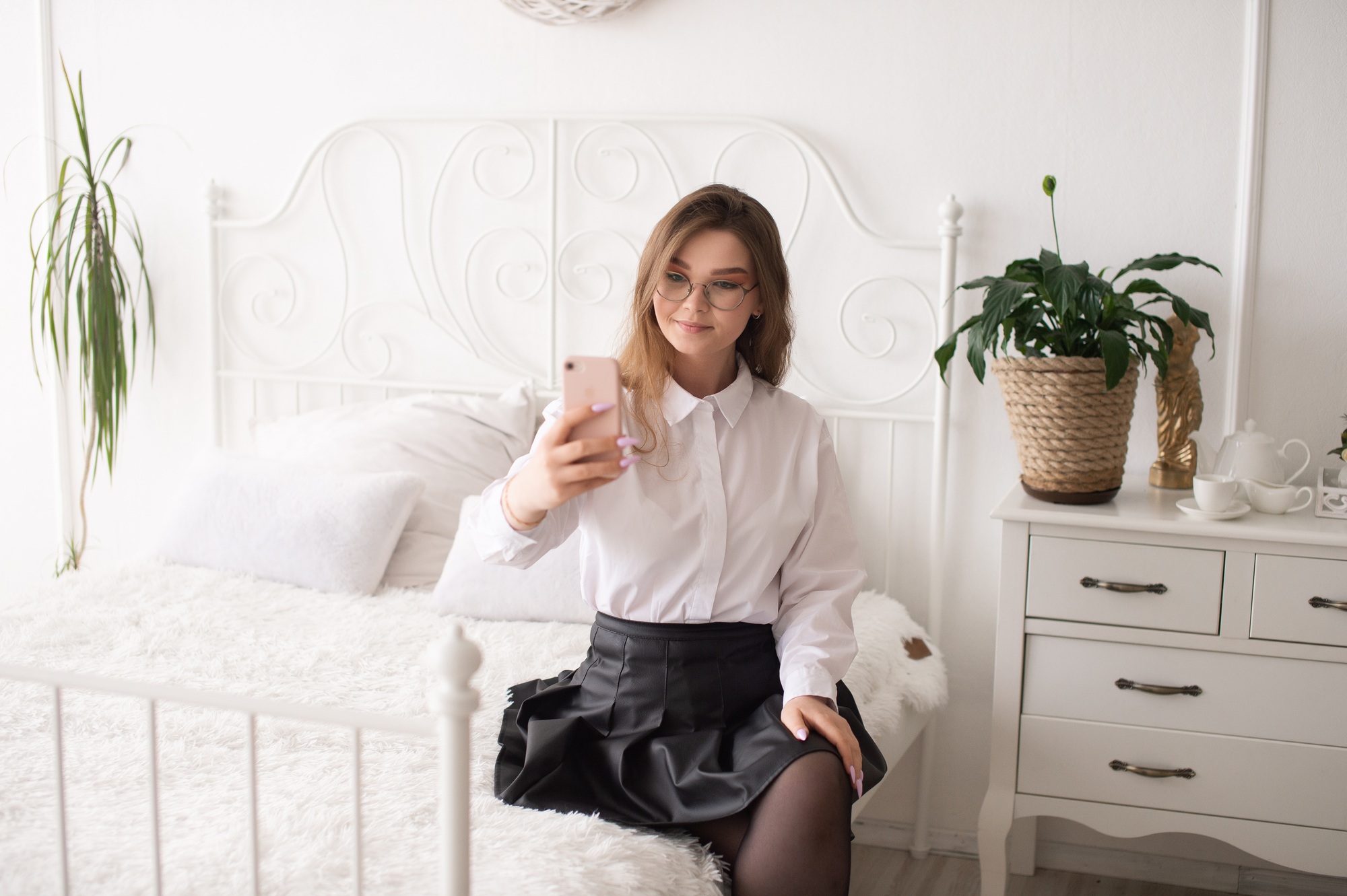 A happy woman has a video call. The girl looks into the phone camera and smiles.