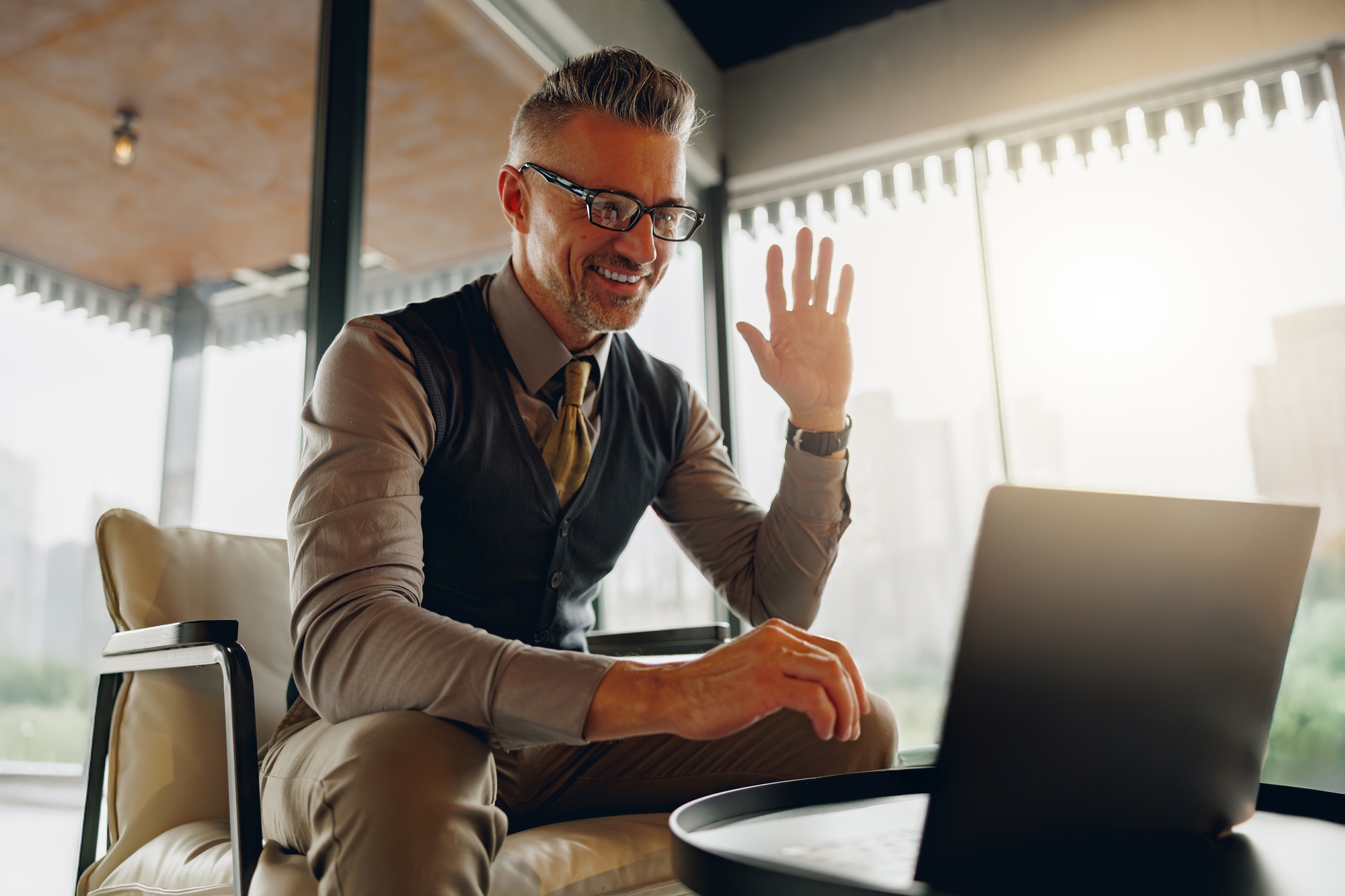 A professional participating in a business meeting conducted through a video call platform