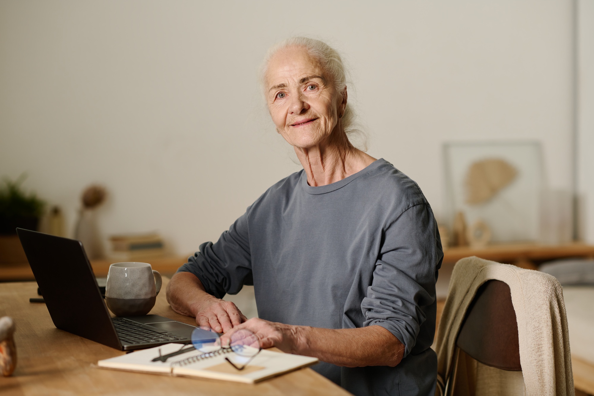 Aged woman sitting in front of laptop