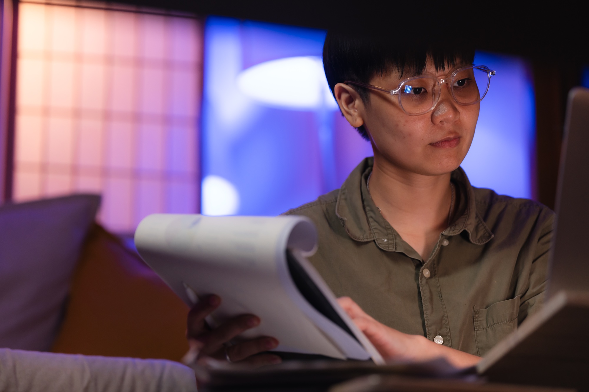 Asian business freelance working hard by using laptop and document paper overtime at Night overload