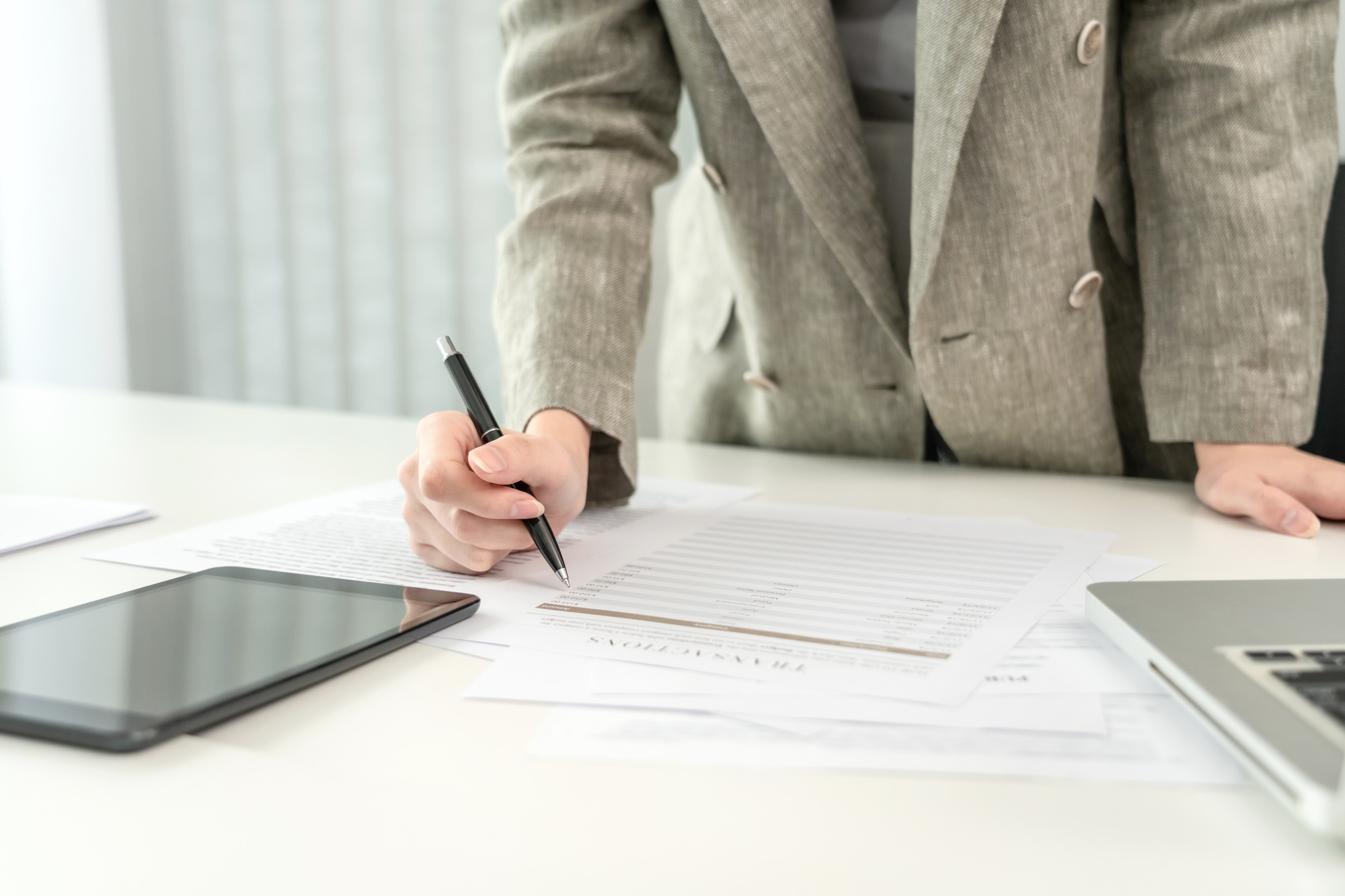 Asian business women are analyzing company sales statistical graphs to develop them further