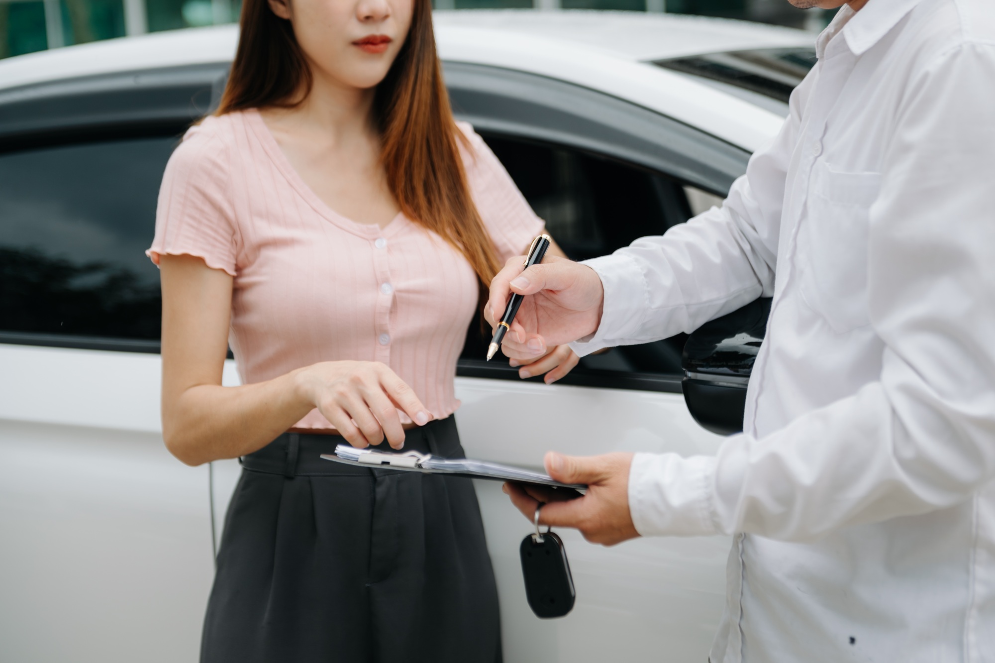 Automotive business, car sale or rental concept Customer with car dealer agent making deal