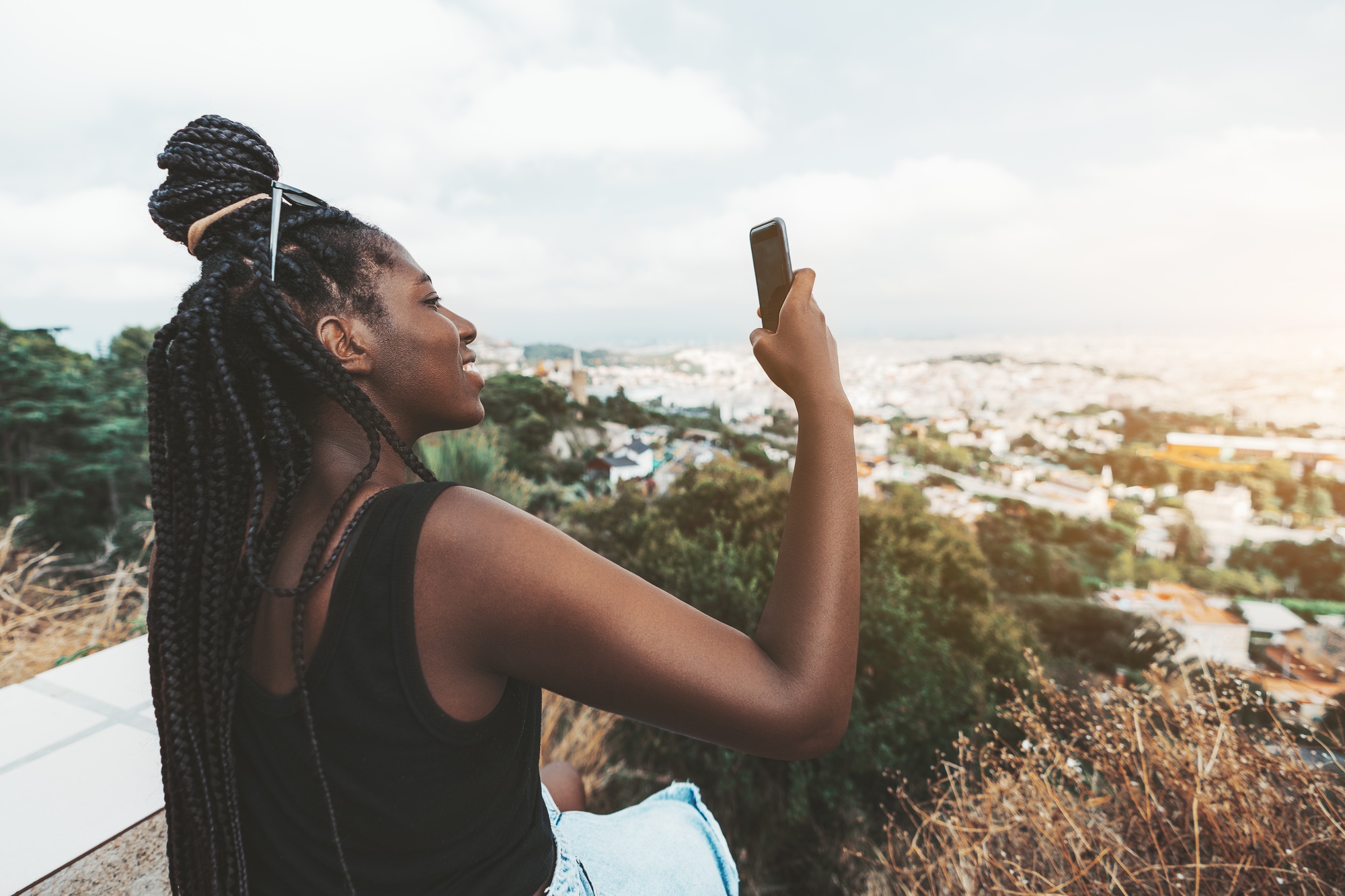 Black girl photographing cityscape