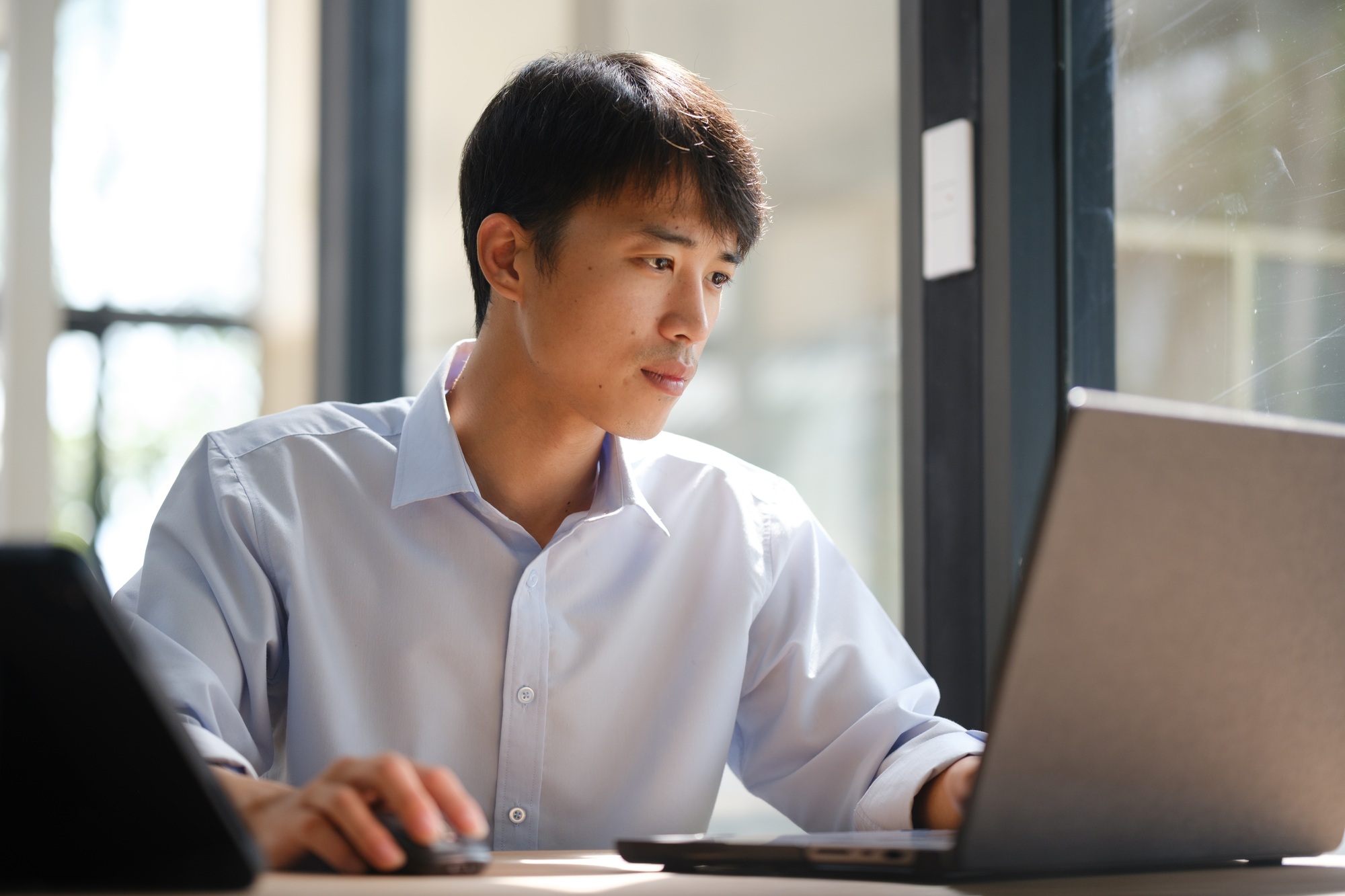 Business consultant analyzing financial data on a laptop