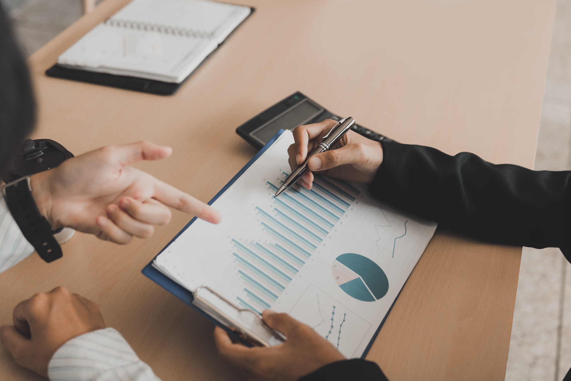 Business people talking and analysis finance cost with checking reports.