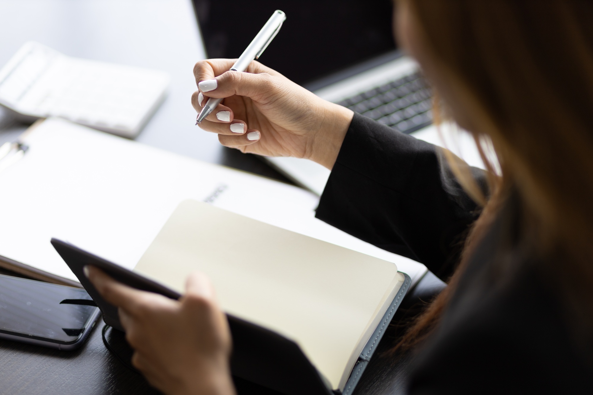 Business woman working in an office writes financial and accounting records.