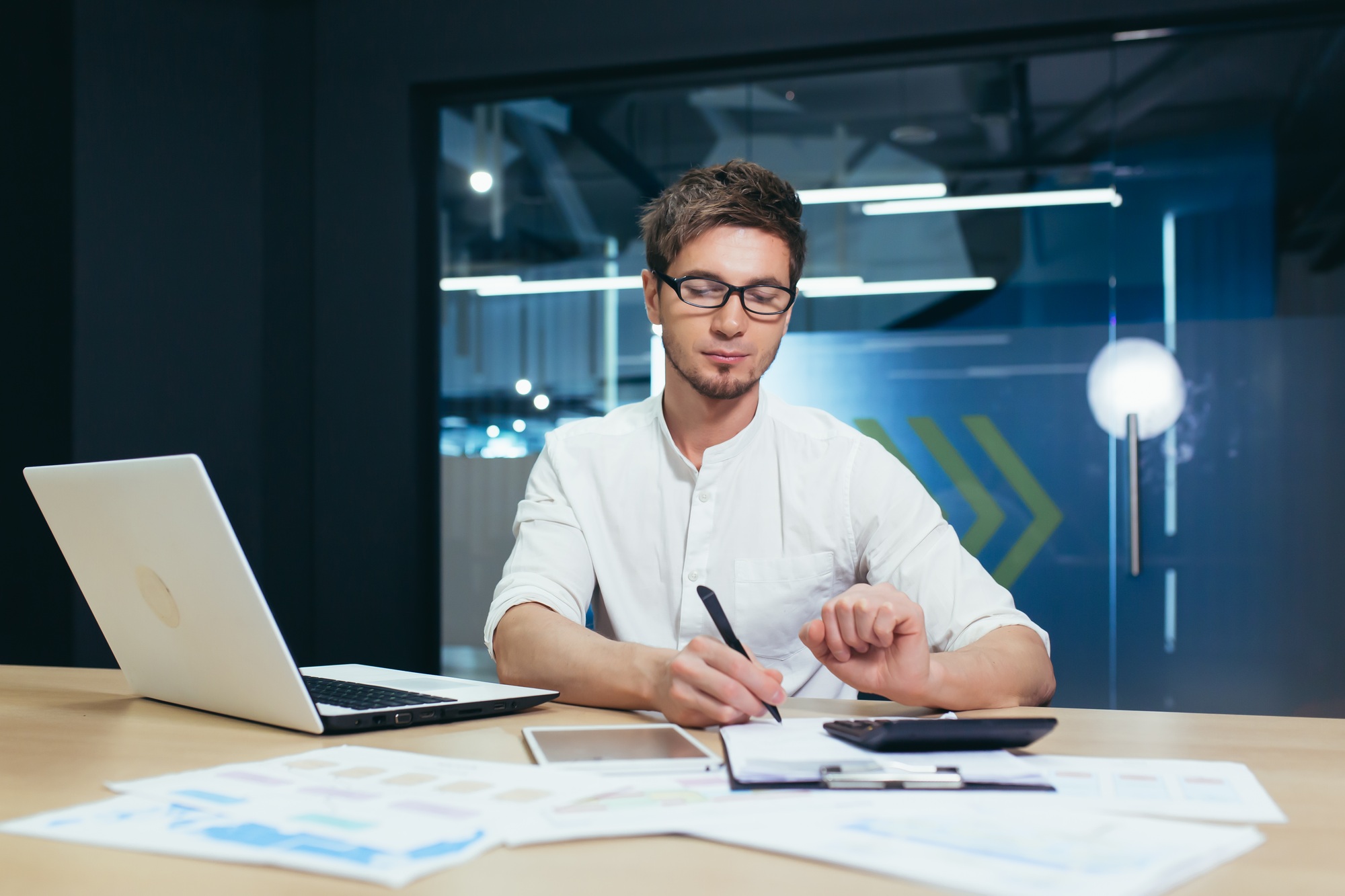 Businessman working with documents and schedules in a modern office
