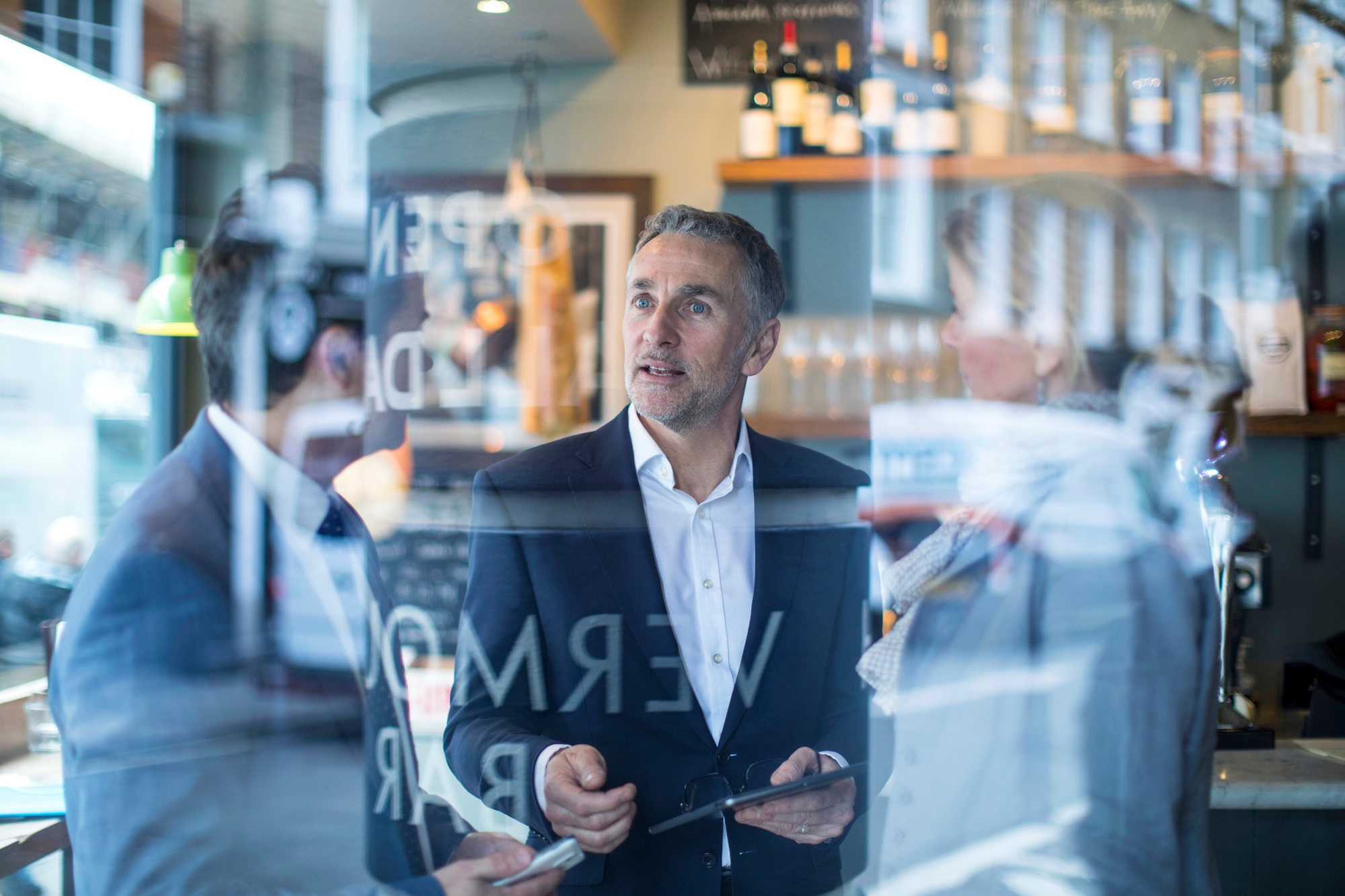 Businessmen and woman having discussion in restaurant