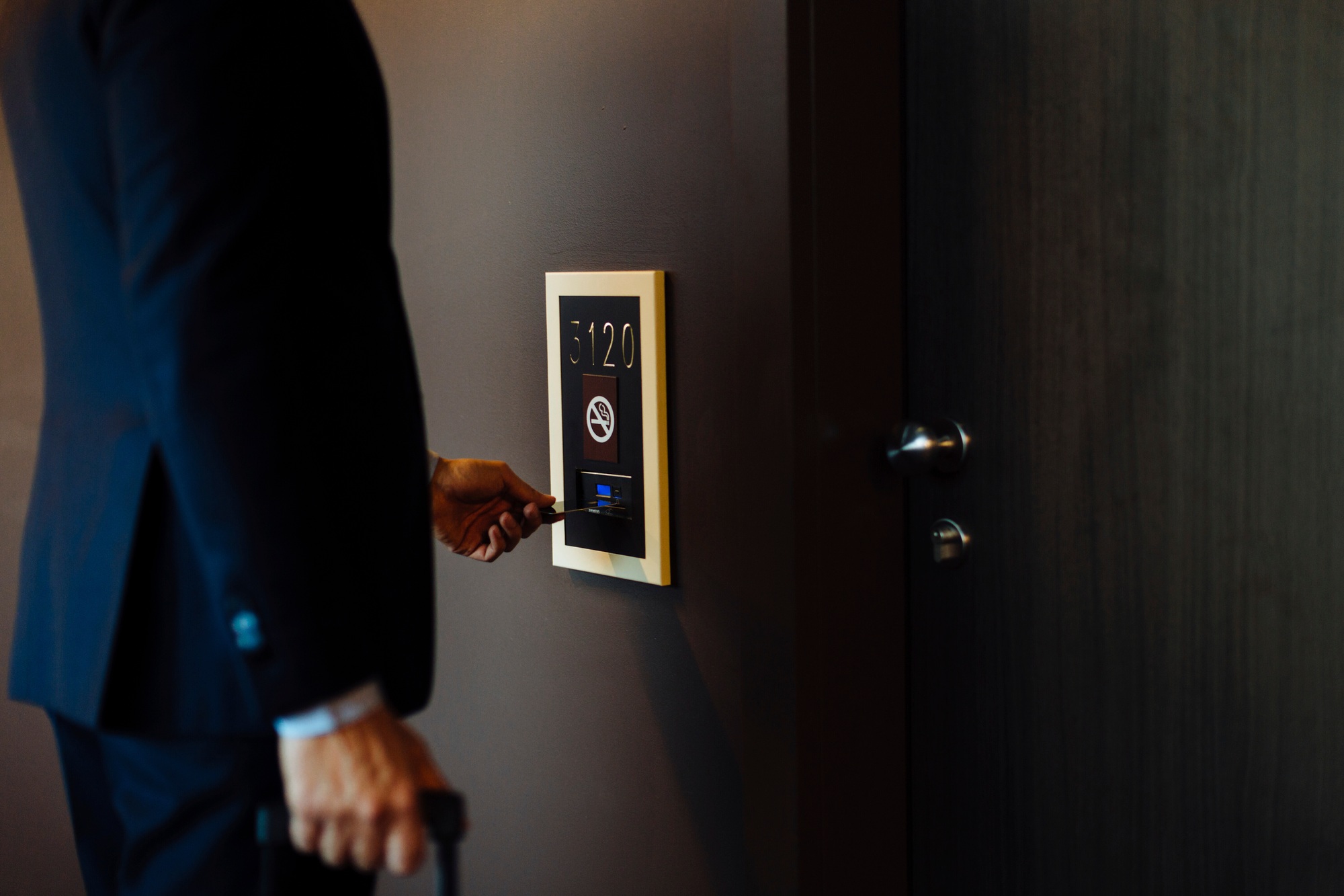 Businessperson checking into a smart security system at the office entrance.