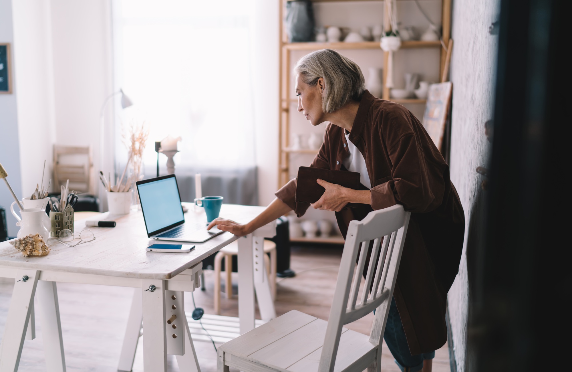 Businesswoman watch on laptop at home art studio