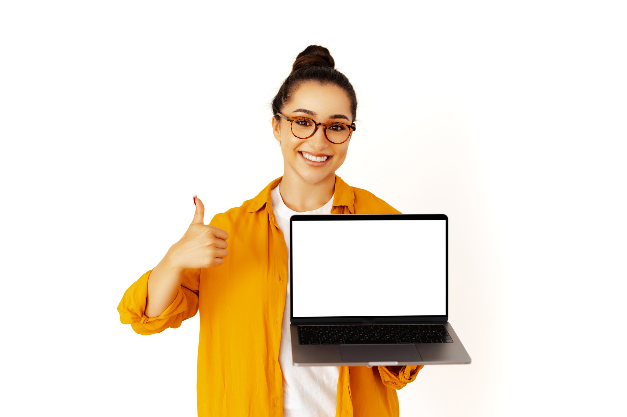 Cheerful woman holding a laptop with a blank white mock-up screen for advertising or presentation