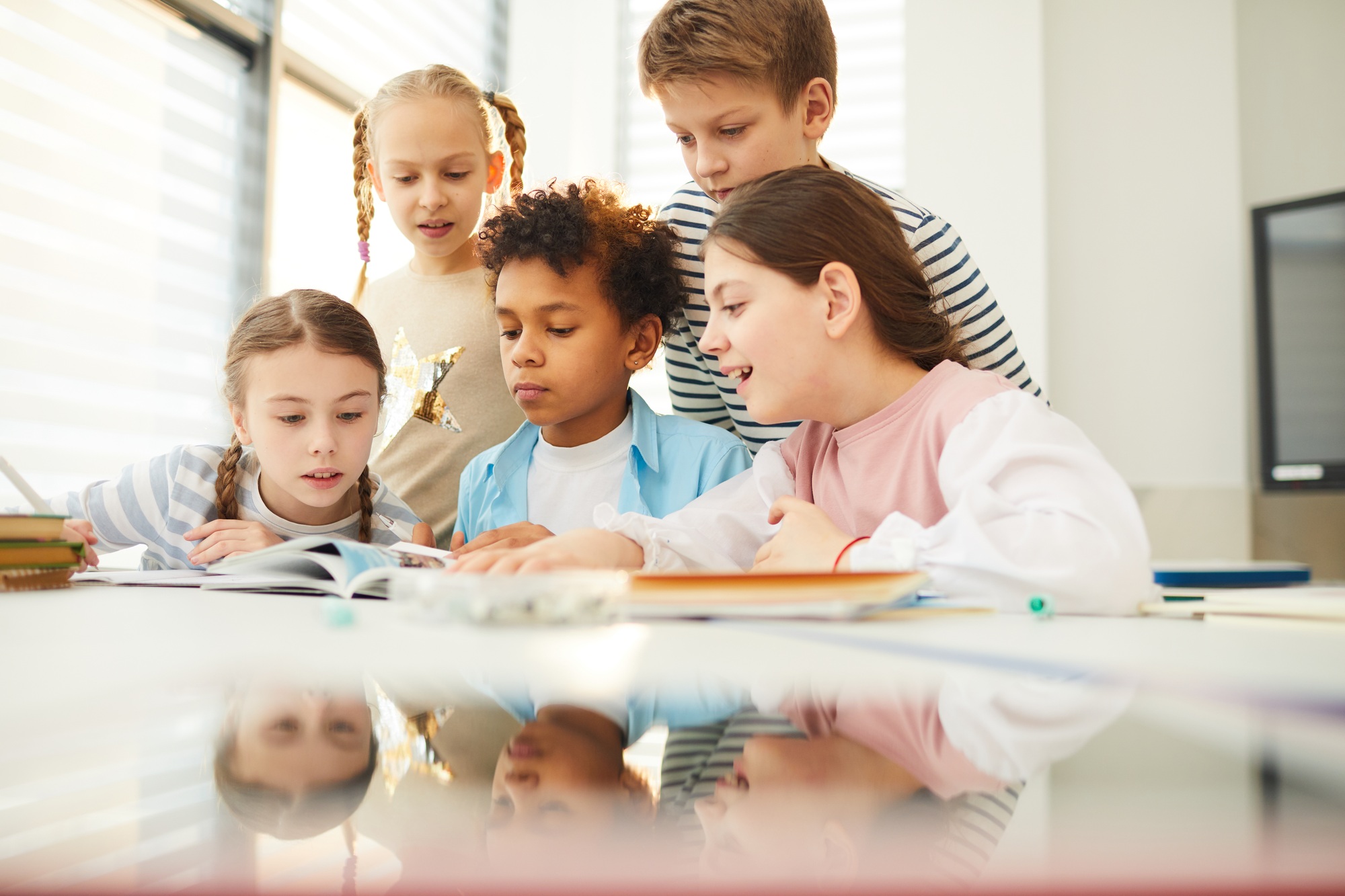 Children Looking Through Book Illustrations