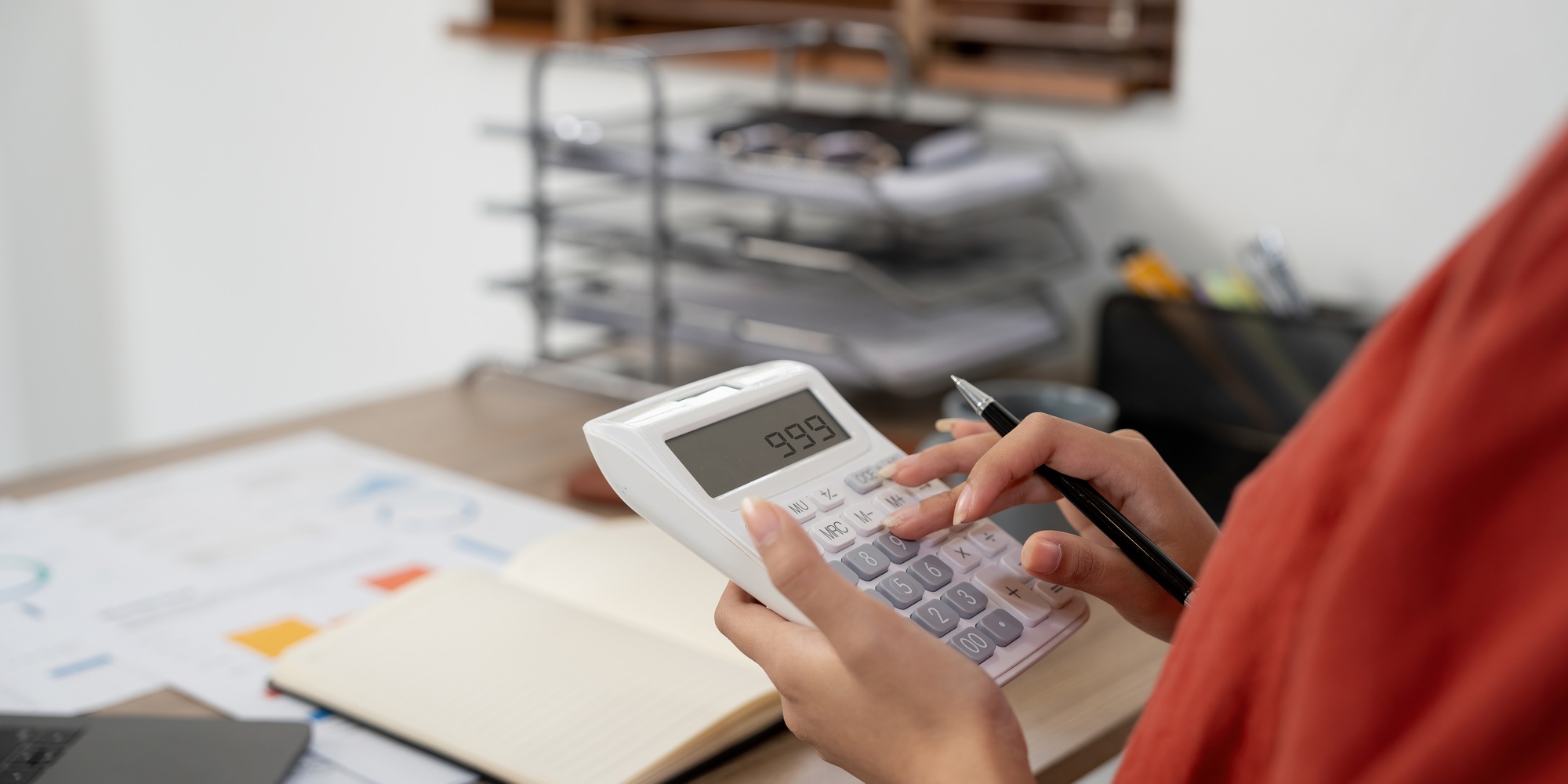 Close up hands businessman doing finances with using calculator for debt or tax.
