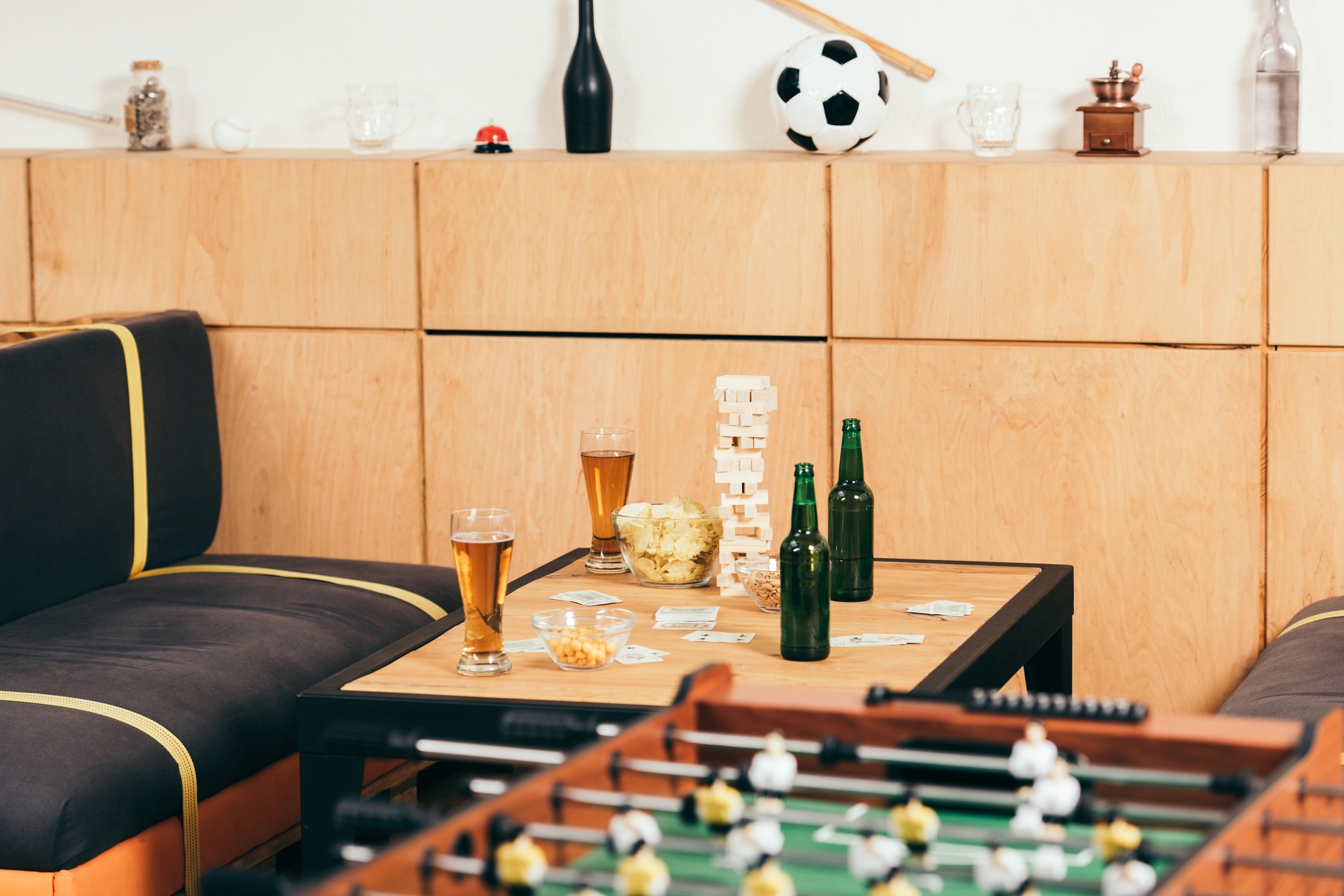 close up view of beer, snacks and blocks wood game on tabletop in cafe