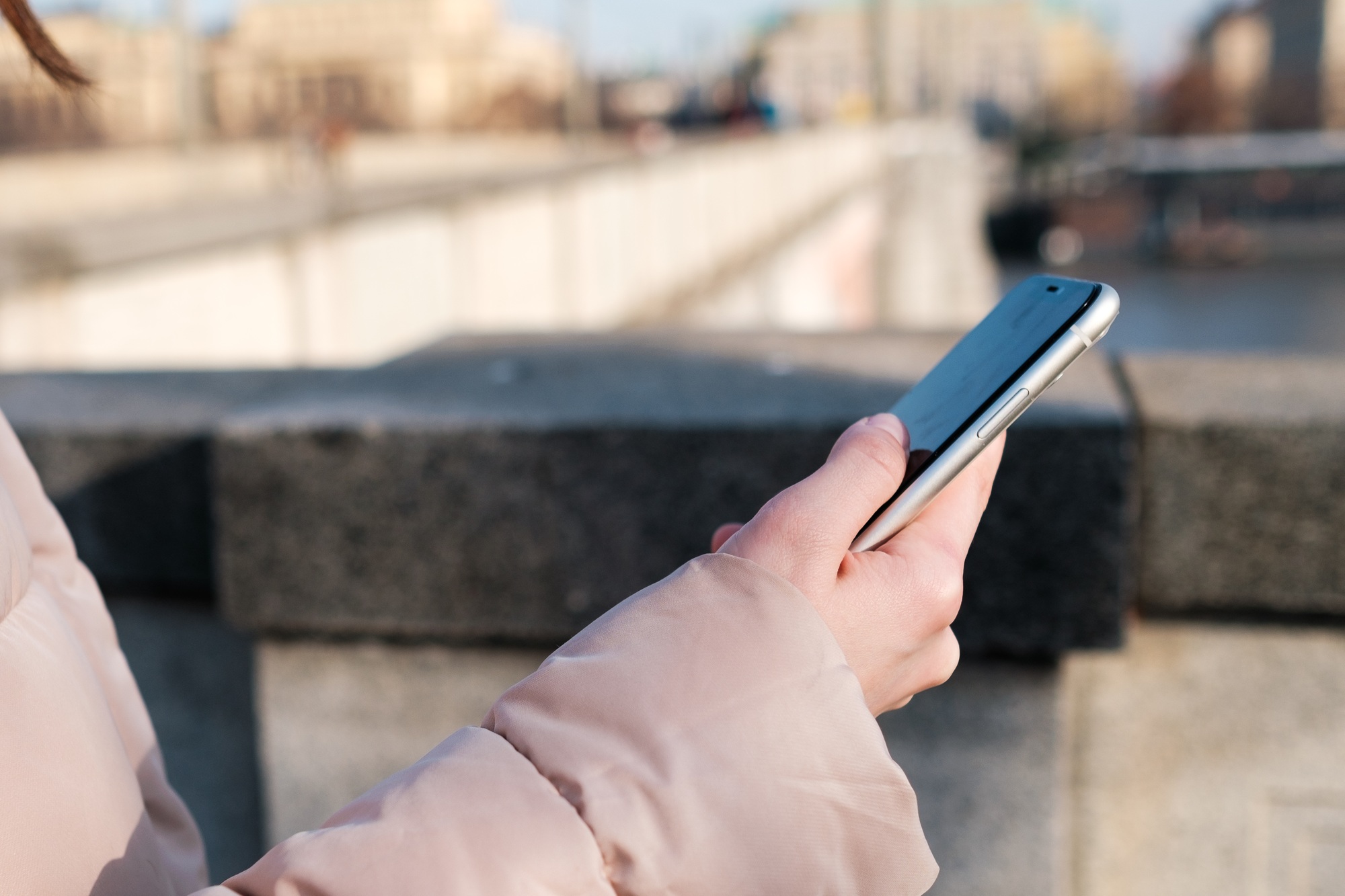 Close up woman hands holding a smartphone. Young girl uses messenger, free wi fi or internet