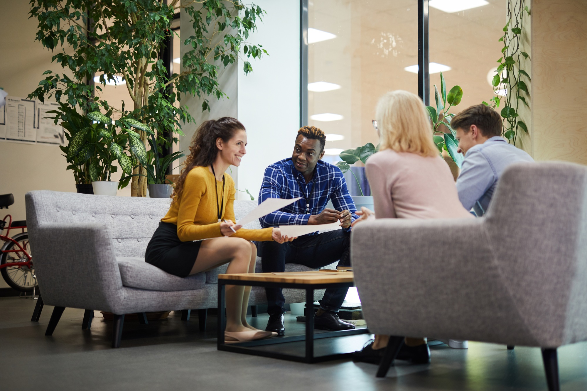 Creative team discussing sales statistics in office