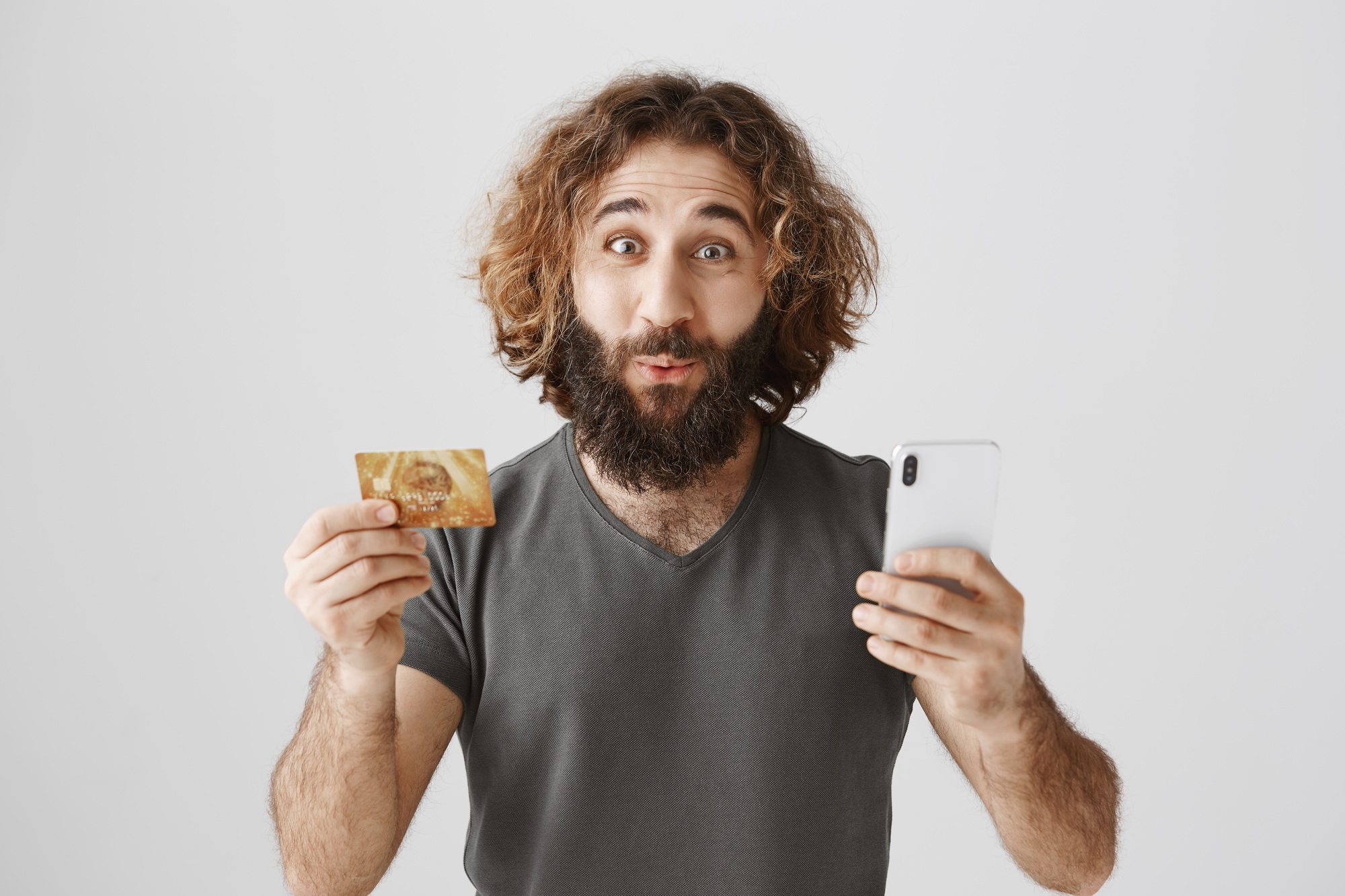 Customer amazed with fast feedback. Portrait of surprised excited eastern guy with curly hair and