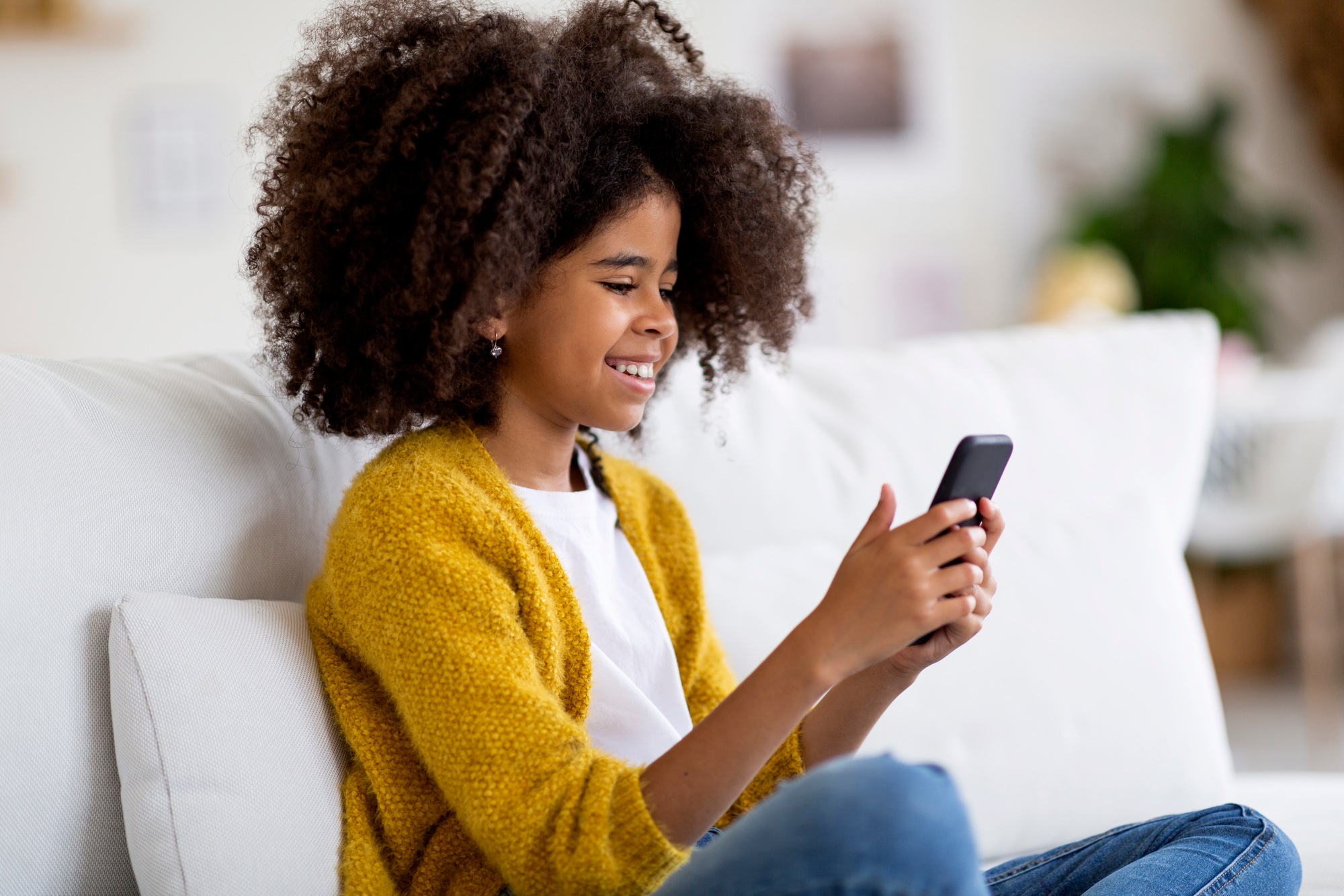 Cute black girl enjoying newest mobile app