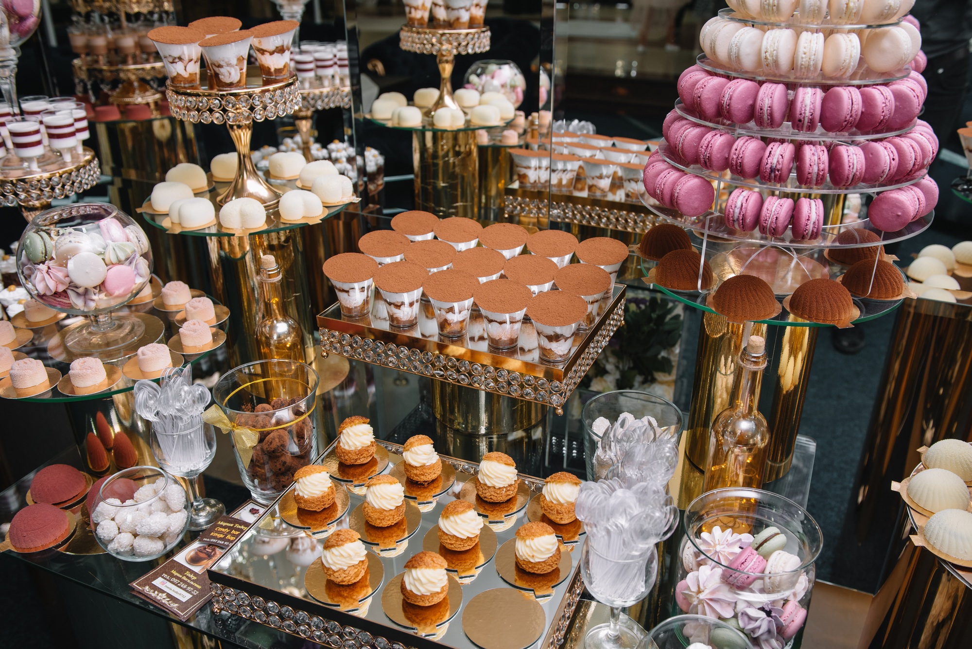 Delicious sweets on candy buffet. Table with sweets, buffet with cupcakes, Macaroons